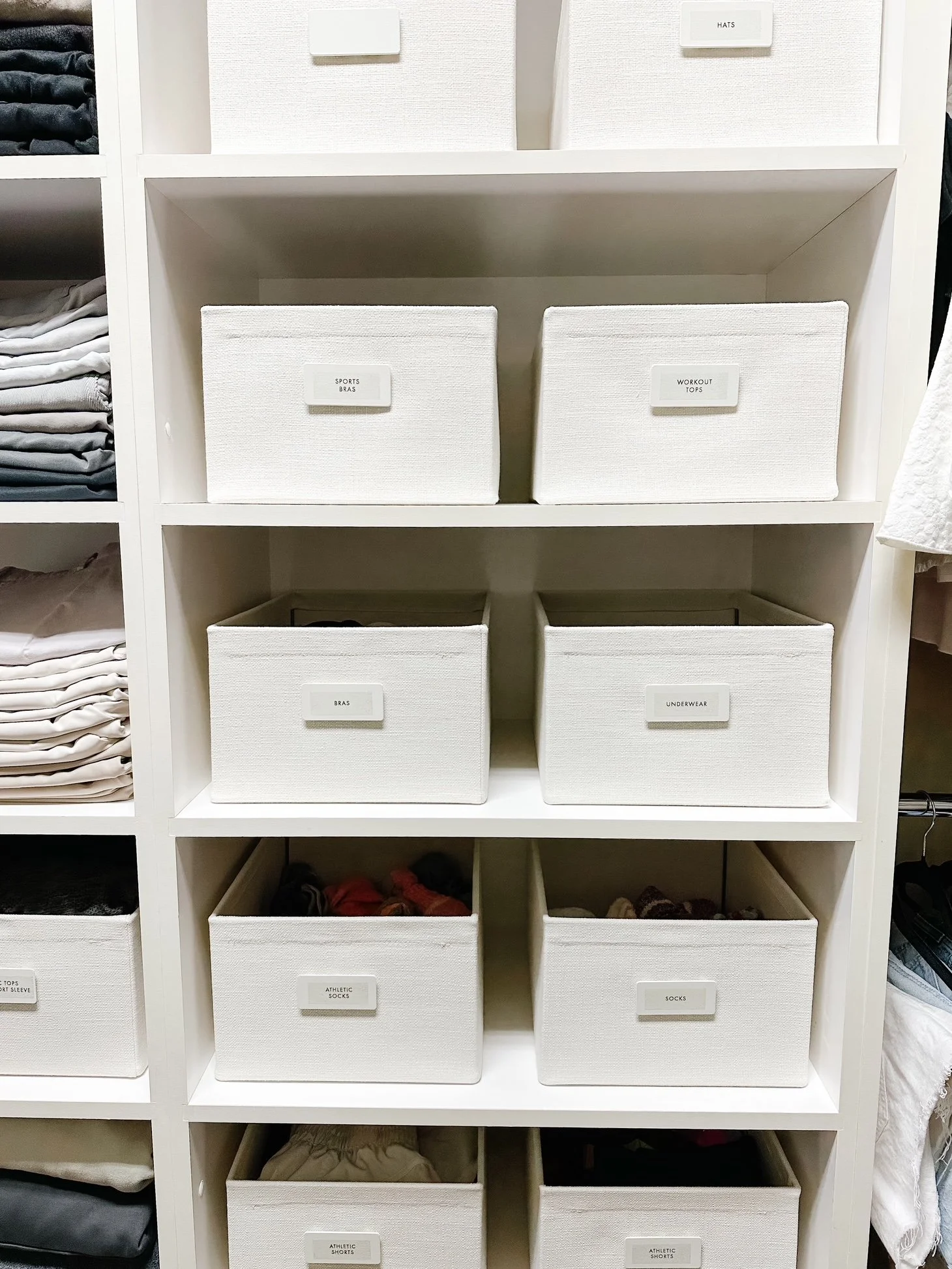 An organized closet with labeled bins