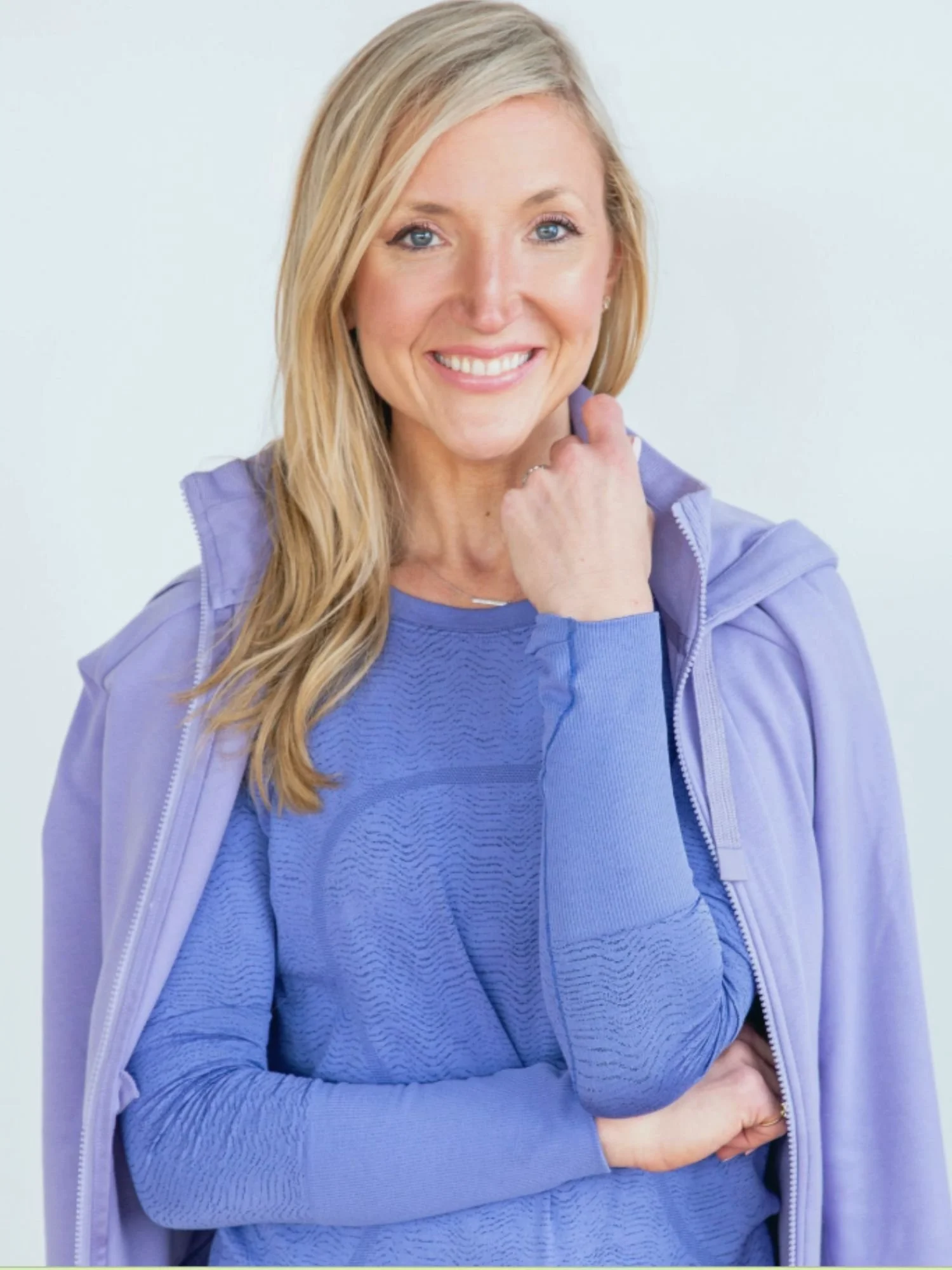 Jen Hirst smiling in a lavender jacket and blue top, featured guest on episode 299 of To 50 and Beyond about daily habits for long lasting sobriety.