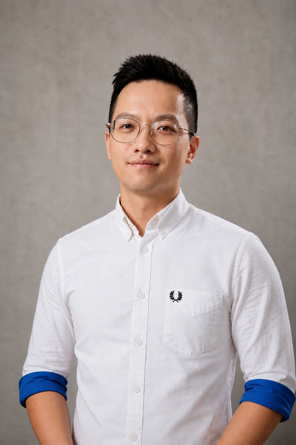 Black and white portrait of a young man wearing glasses and a white button-up shirt.