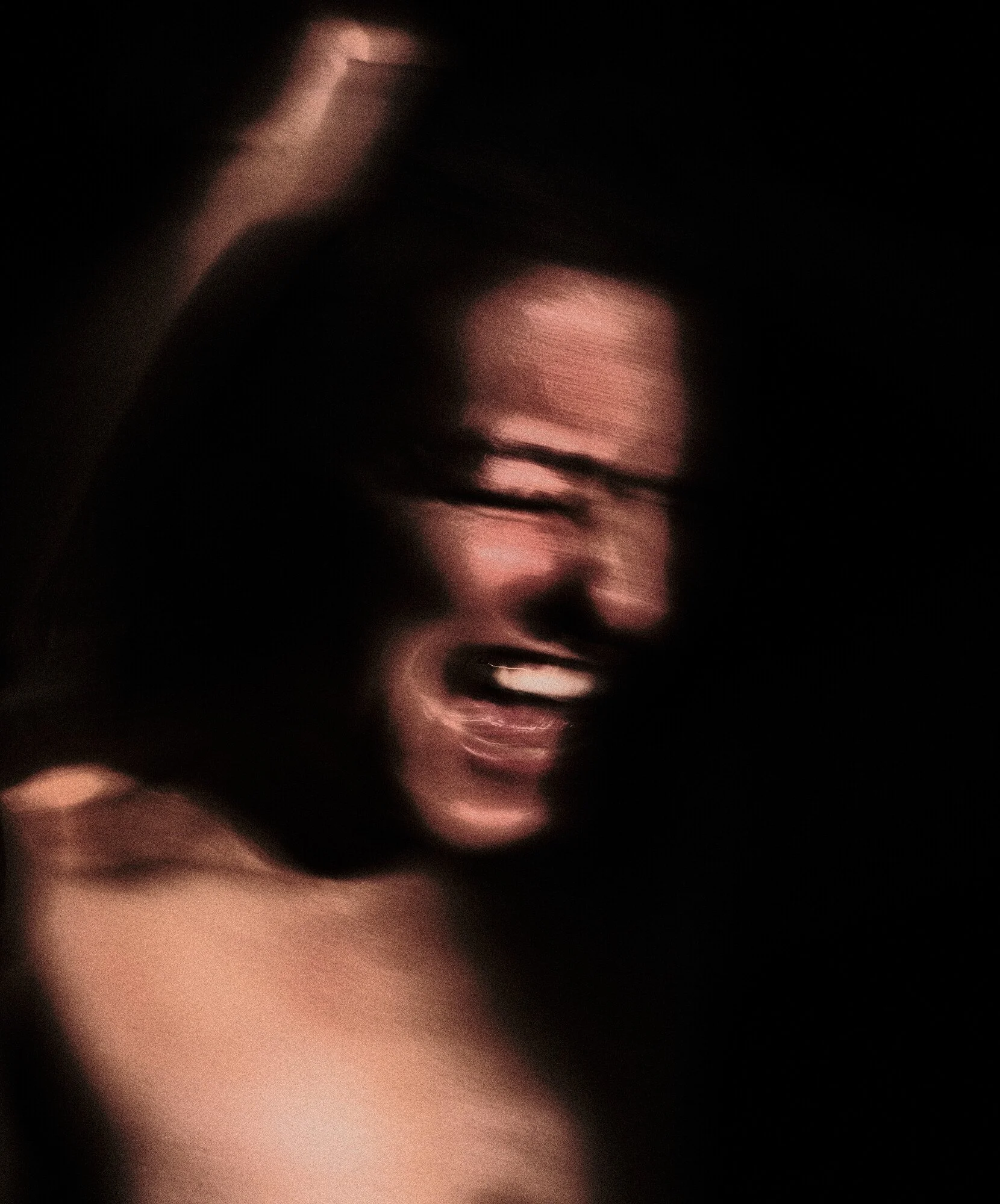 A person appears to be in motion, with blurred features, showing a joyful or excited expression, against a dark background.