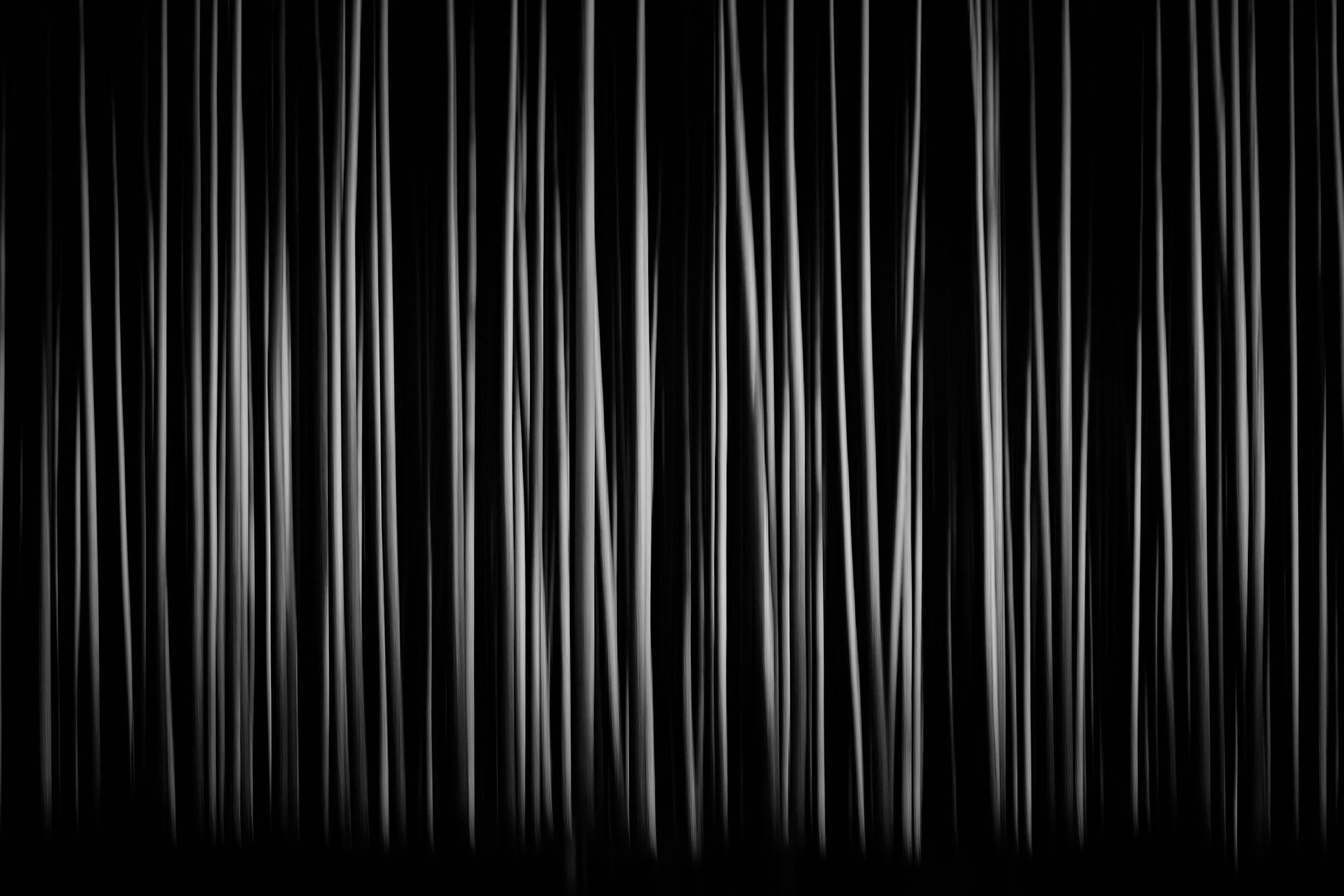 Vertical strings of white light against a black background.