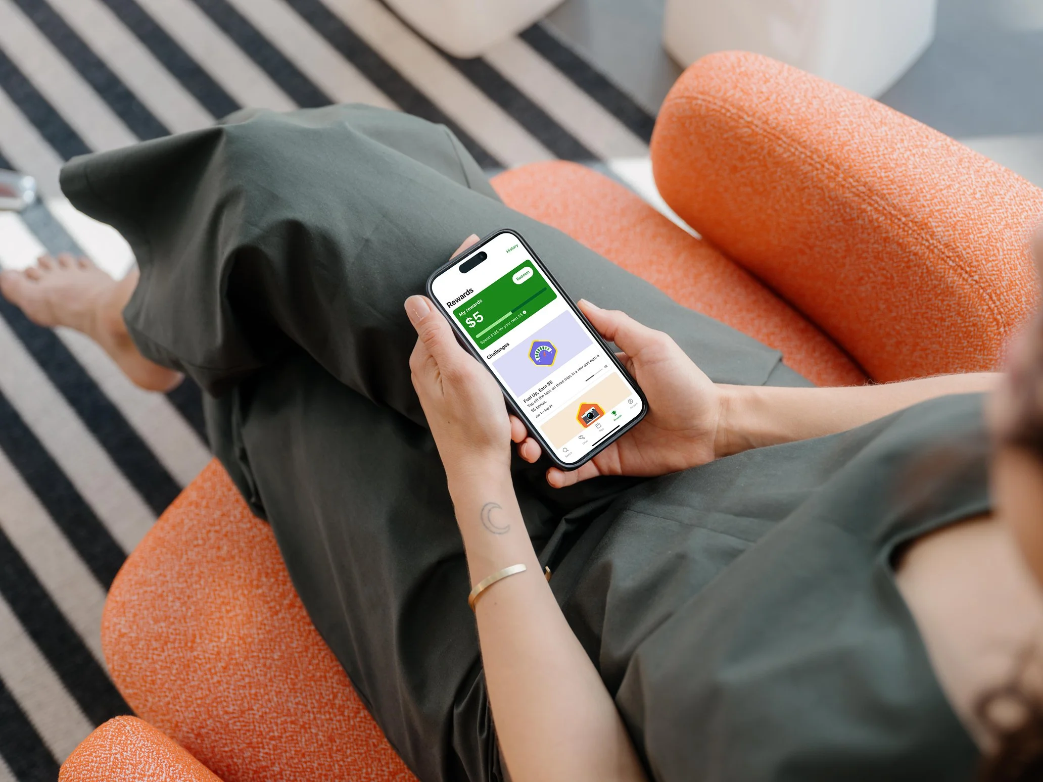 mockuuups-iphone-15-pro-mockup-in-a-womans-hand-on-a-cozy-couch.jpeg