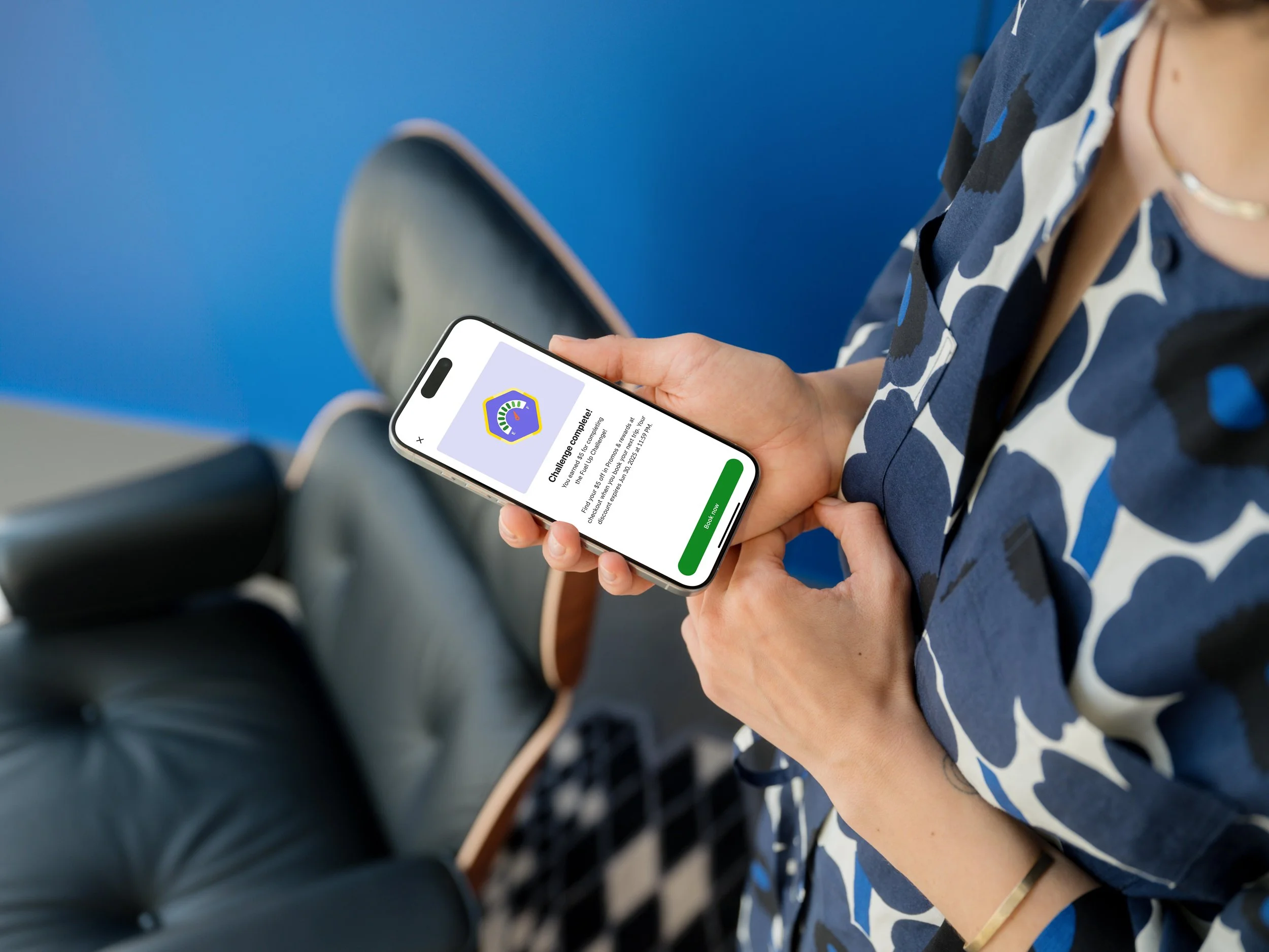 mockuuups-iphone-15-pro-mockup-in-womans-hand-against-blue-background.jpeg