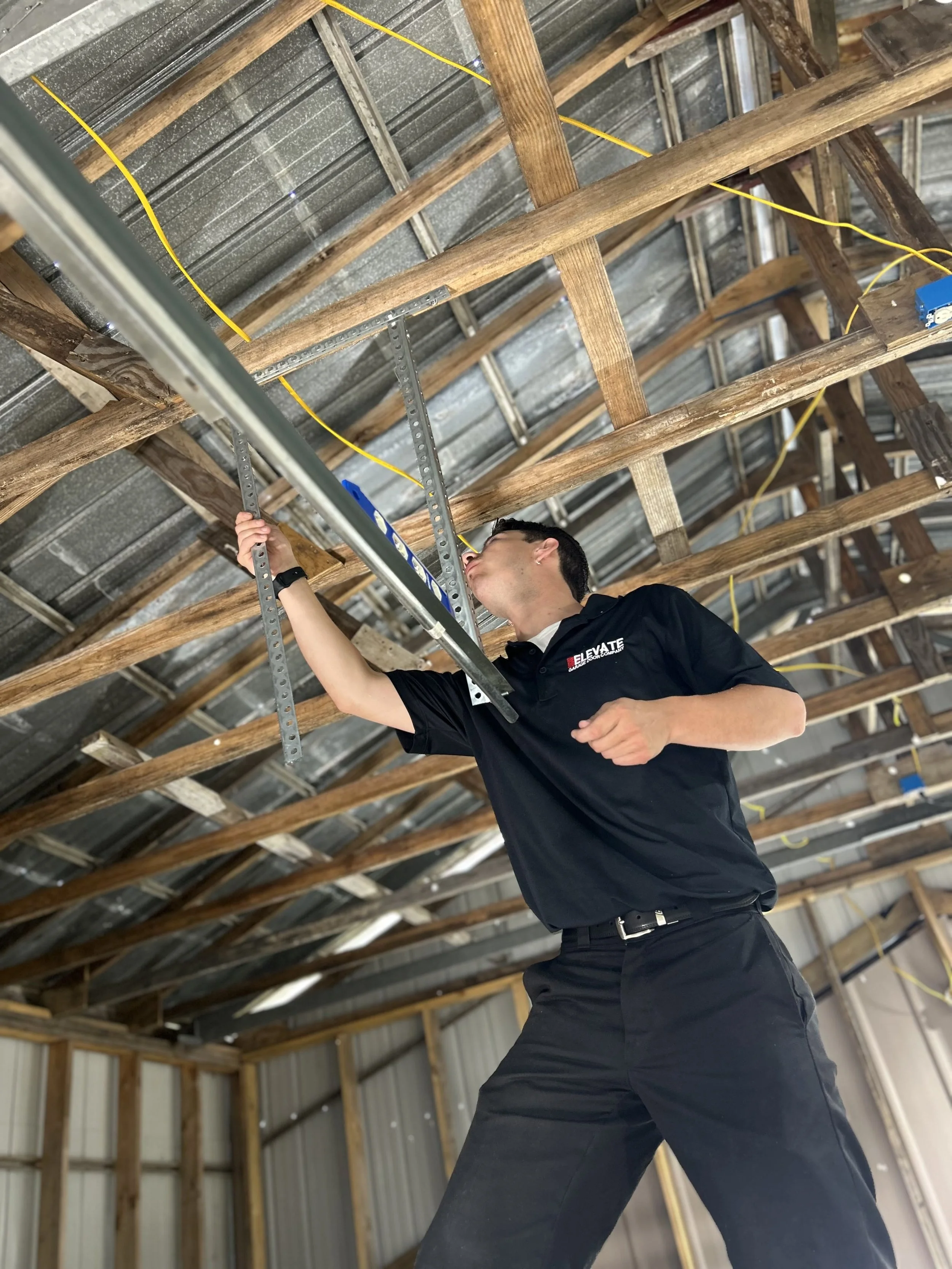 Elevate Garage Door Company technician performing a garage door repair in Mountain Home, Arkansas. Focused inspection and maintenance ensure long-lasting, safe operation for residential garage doors.
