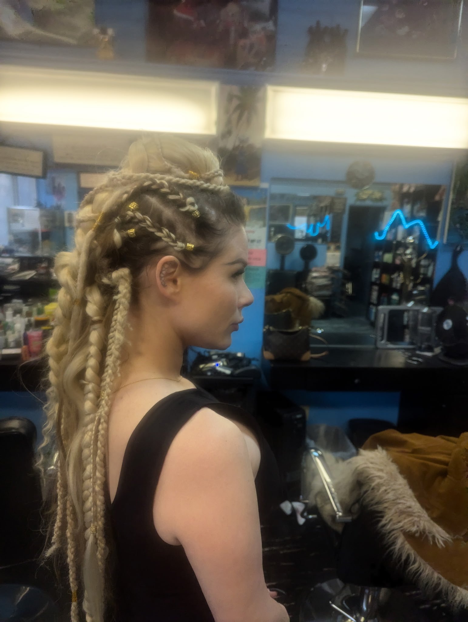 Woman with intricate braided hairstyle in a hair salon