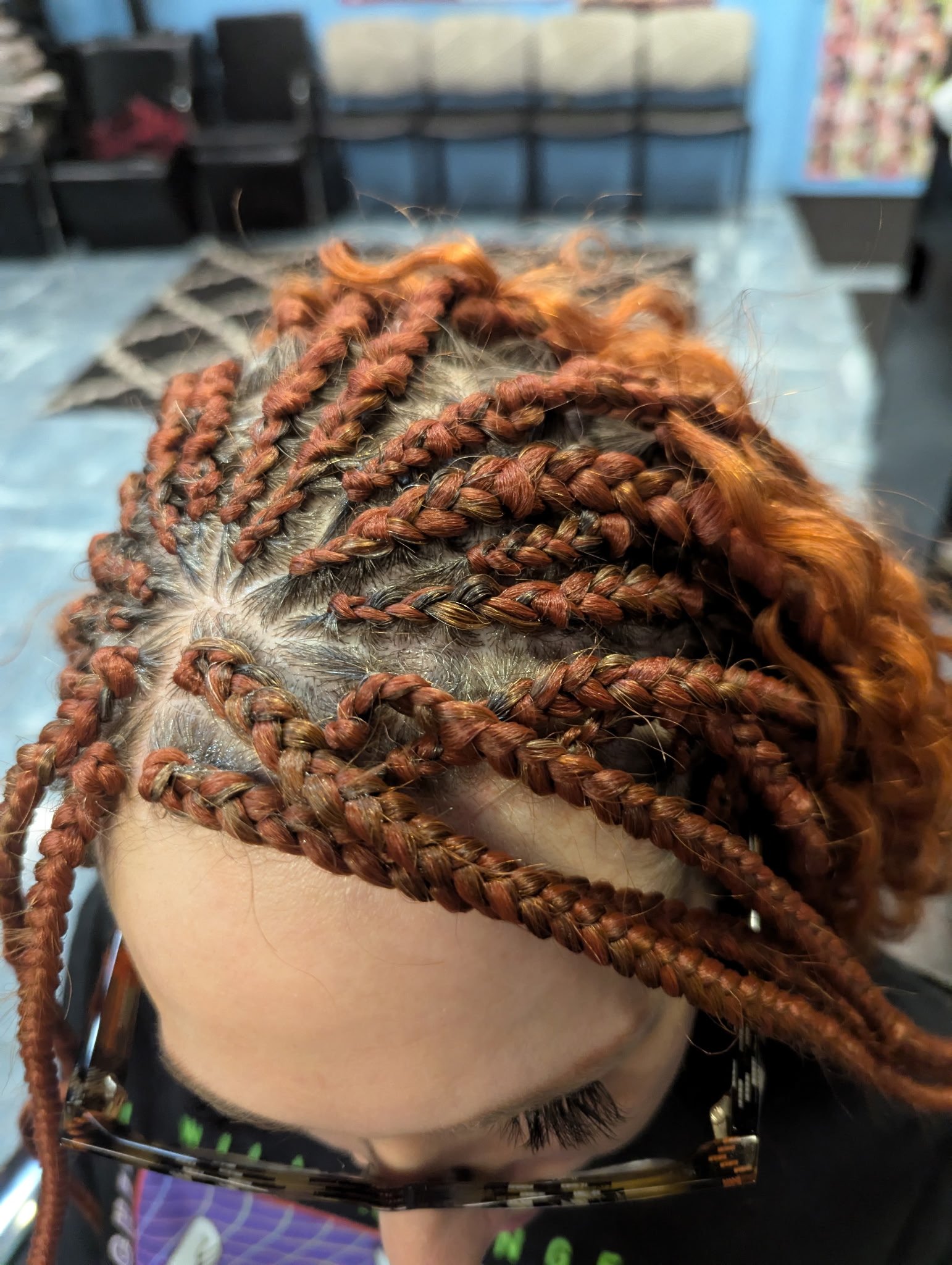 Close-up of scalp with intricate braids and curly hair