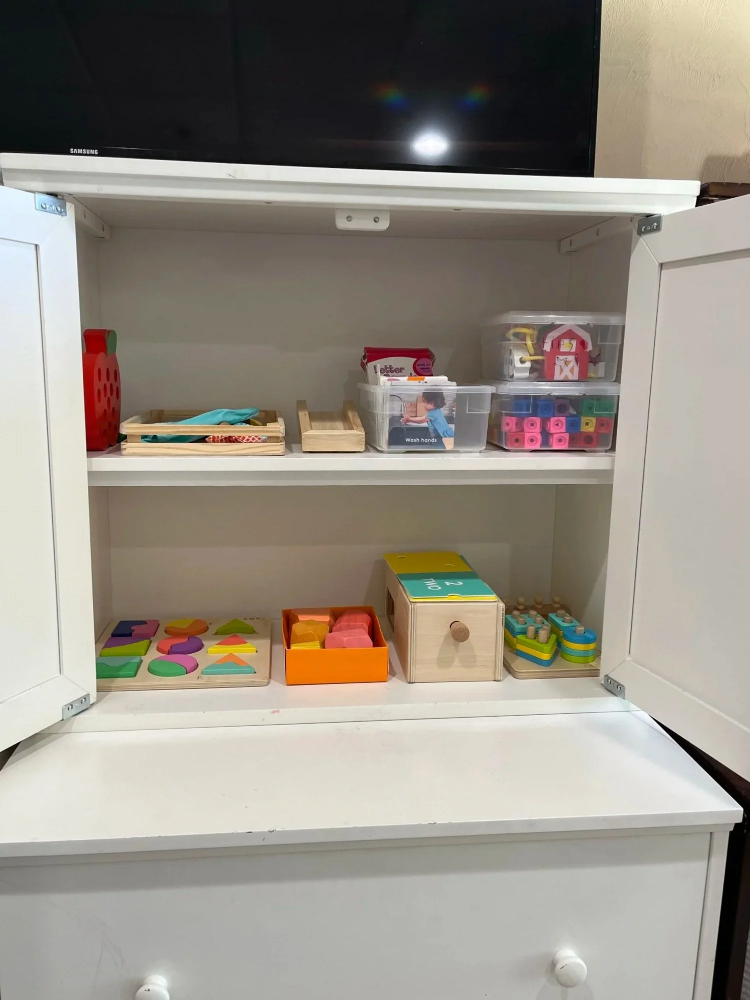 a peaceful home professional organizing reorganized playroom shelves for baby toys
