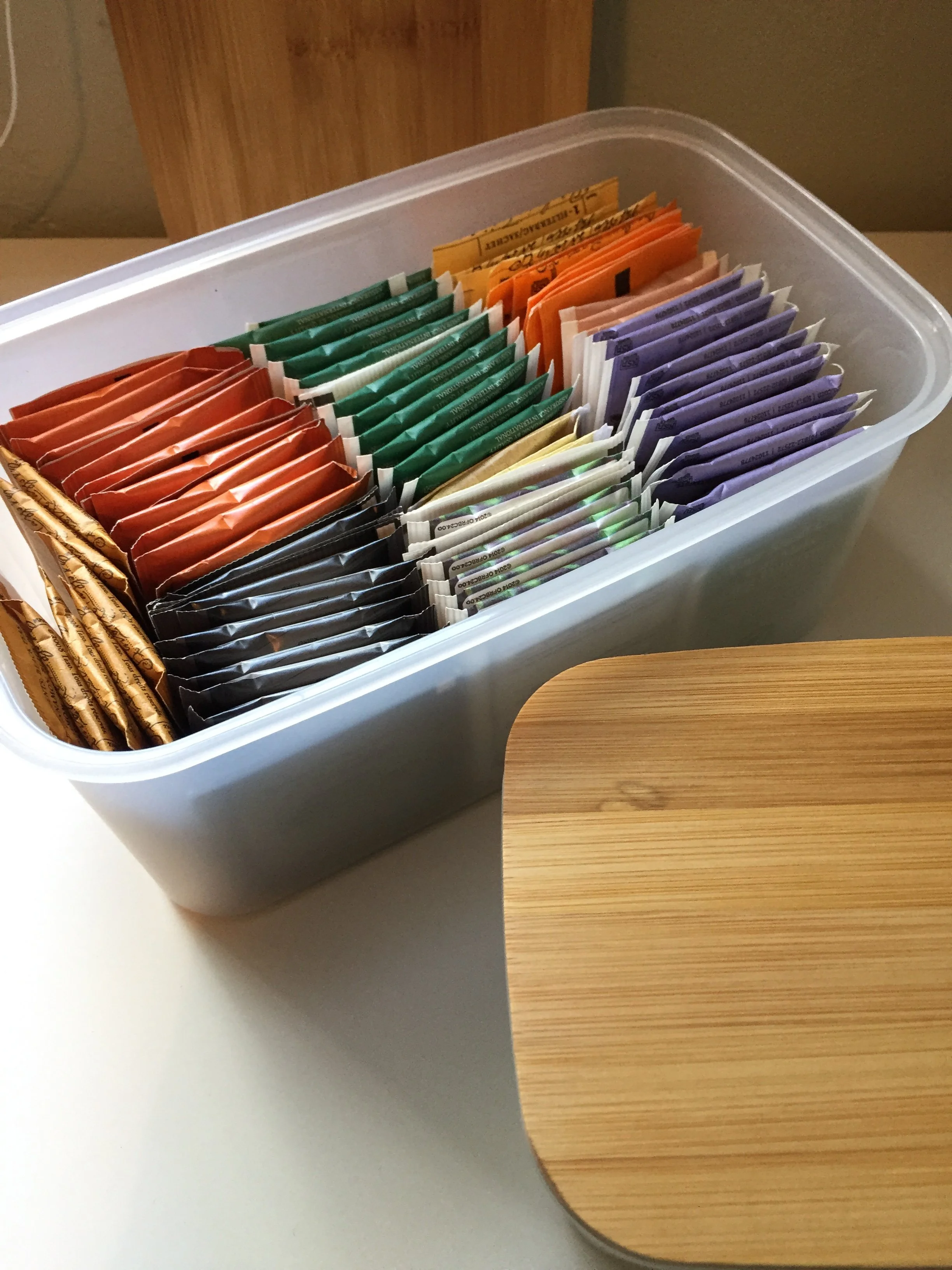 a peaceful home expert decluttering and organized kitchen storage tea storage solution