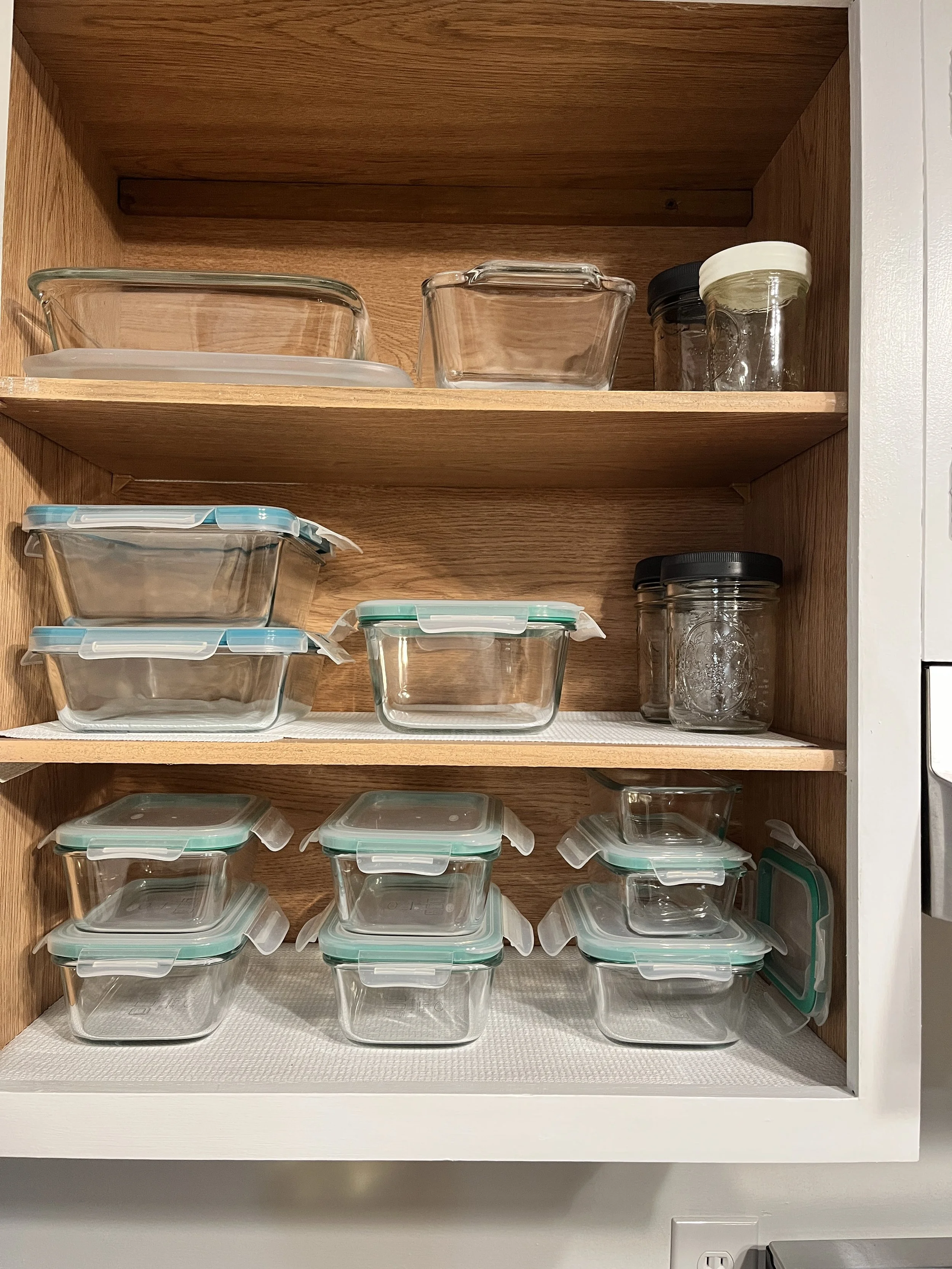 a peaceful home expert decluttering and organized kitchen storage for stacked food storage containers
