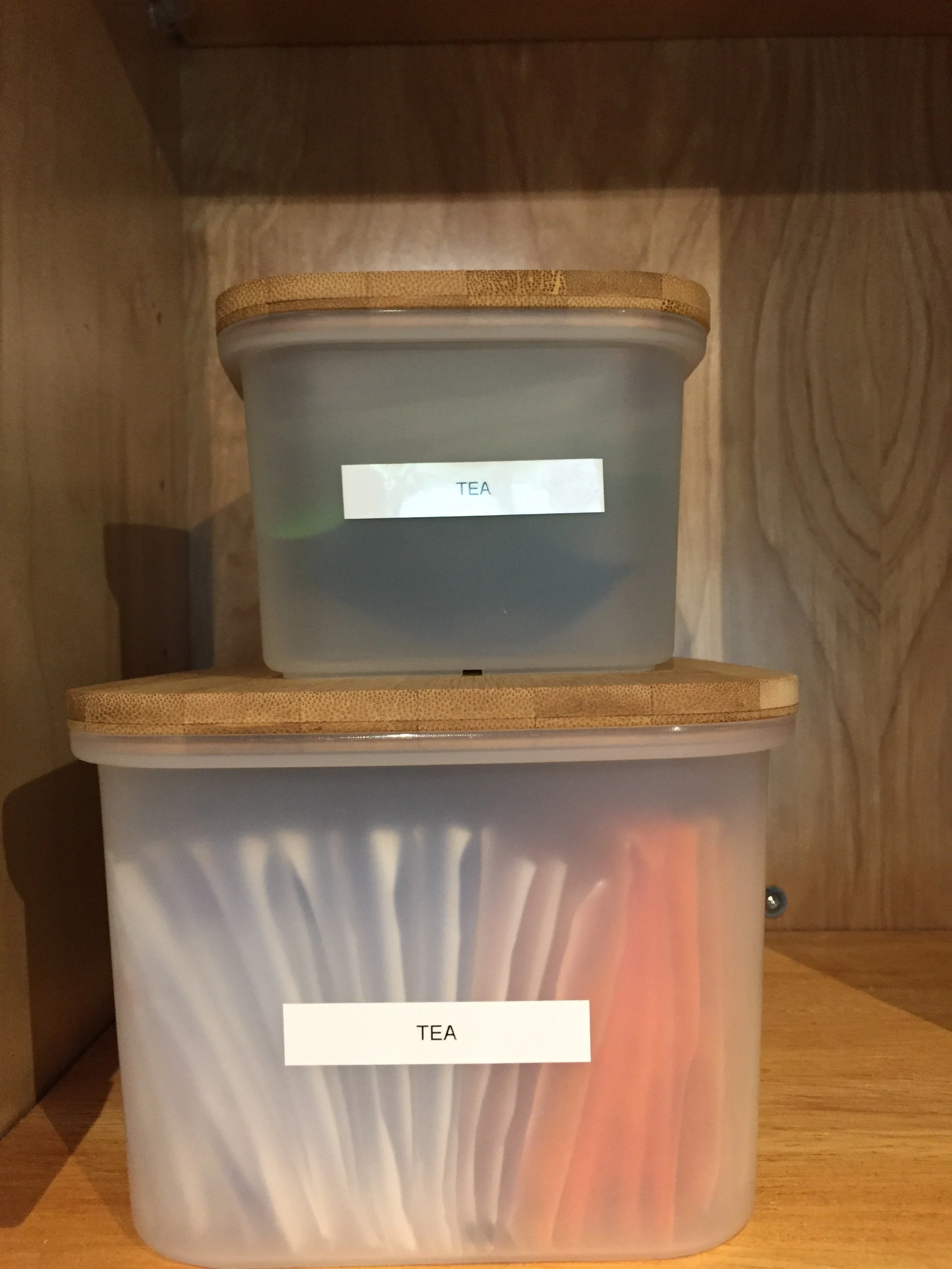 a peaceful home expert decluttering and organized kitchen storage of tea in cabinet
