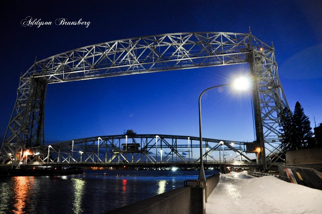 Indoor stage with a Premium DJ performing, elegant large glass windows, and surrounded by speakers and stage equipment.