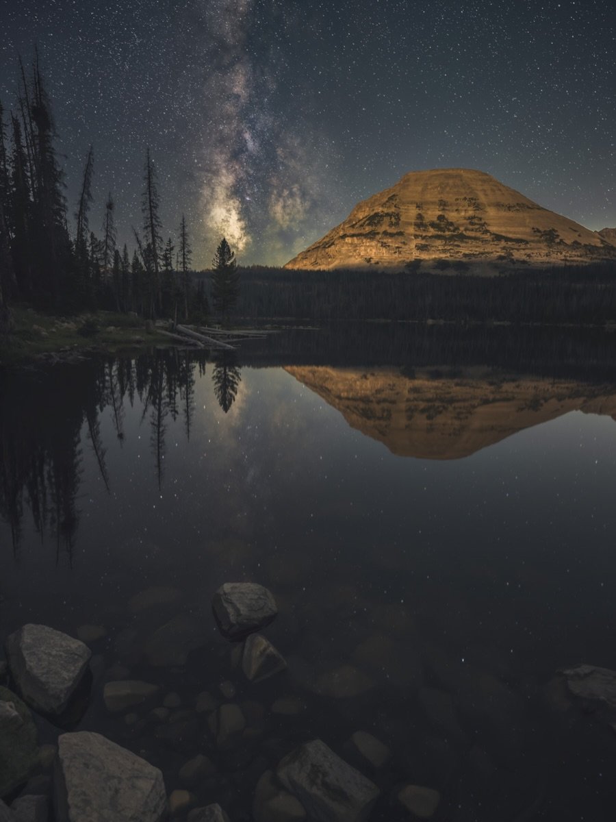 Moonlight Over Bald Mountain 🌙✨

While visiting Mirror Lake in Utah, I knew I wanted to capture the Milky Way reflecting across the water with Bald Mountain in the distance. At 11,948 feet, Bald Mountain is one of those landmarks that immediately gr