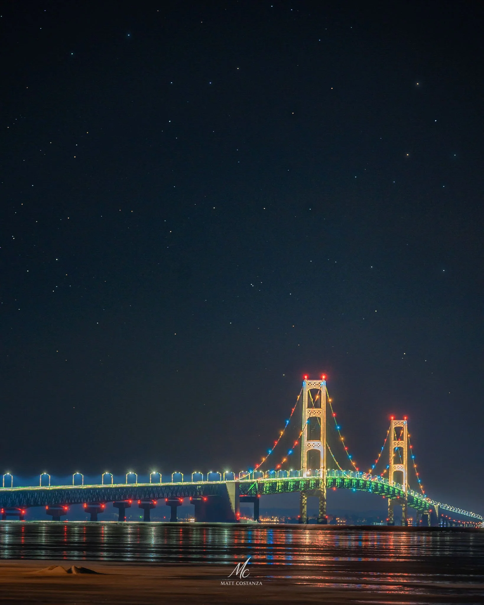 Mackinac Bridge lit at night under starry sky, Upper Peninsula, Michigan