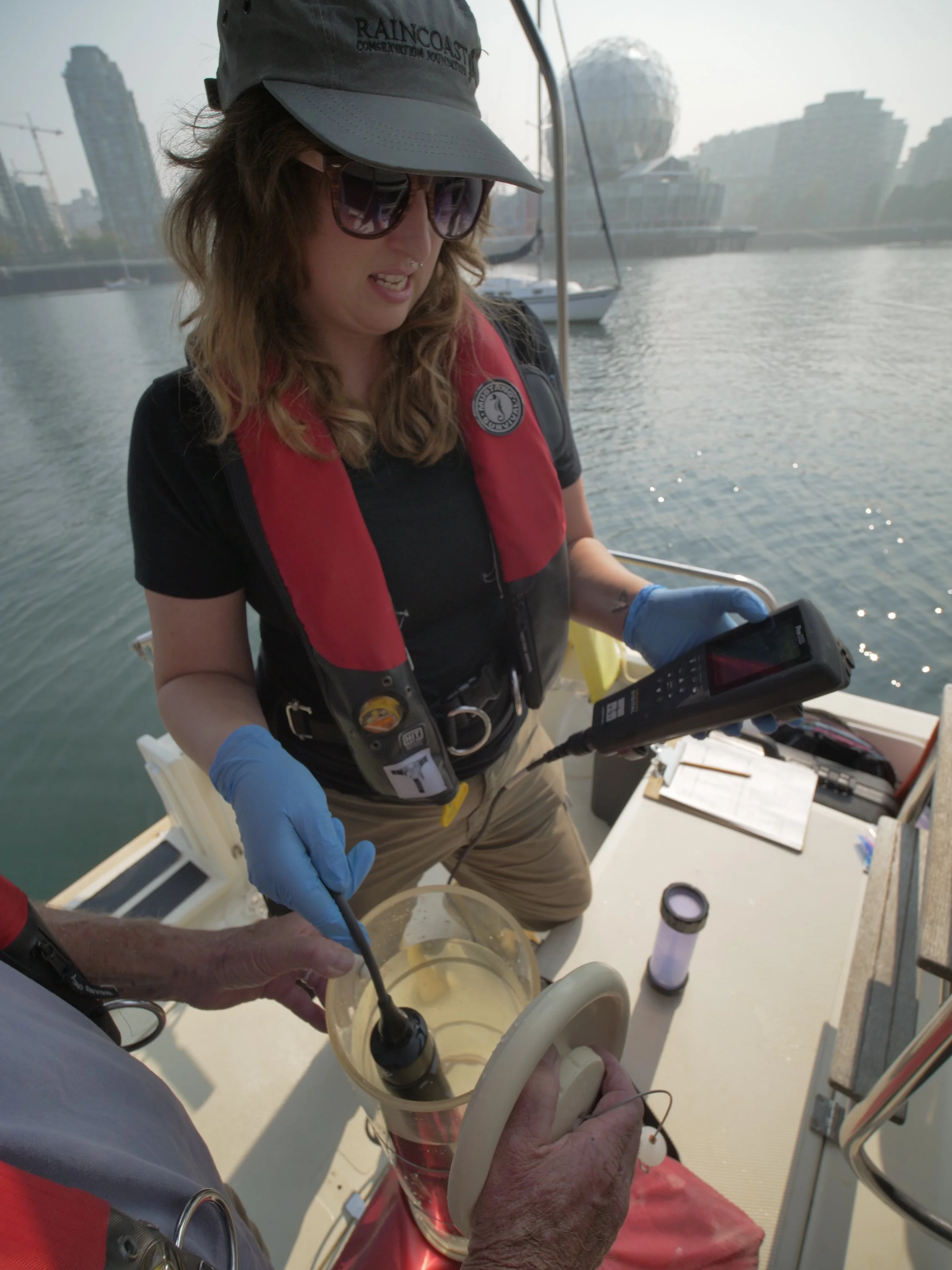 Sam Scott and Zaida use a YSI meter to record water parameters in False Creek
