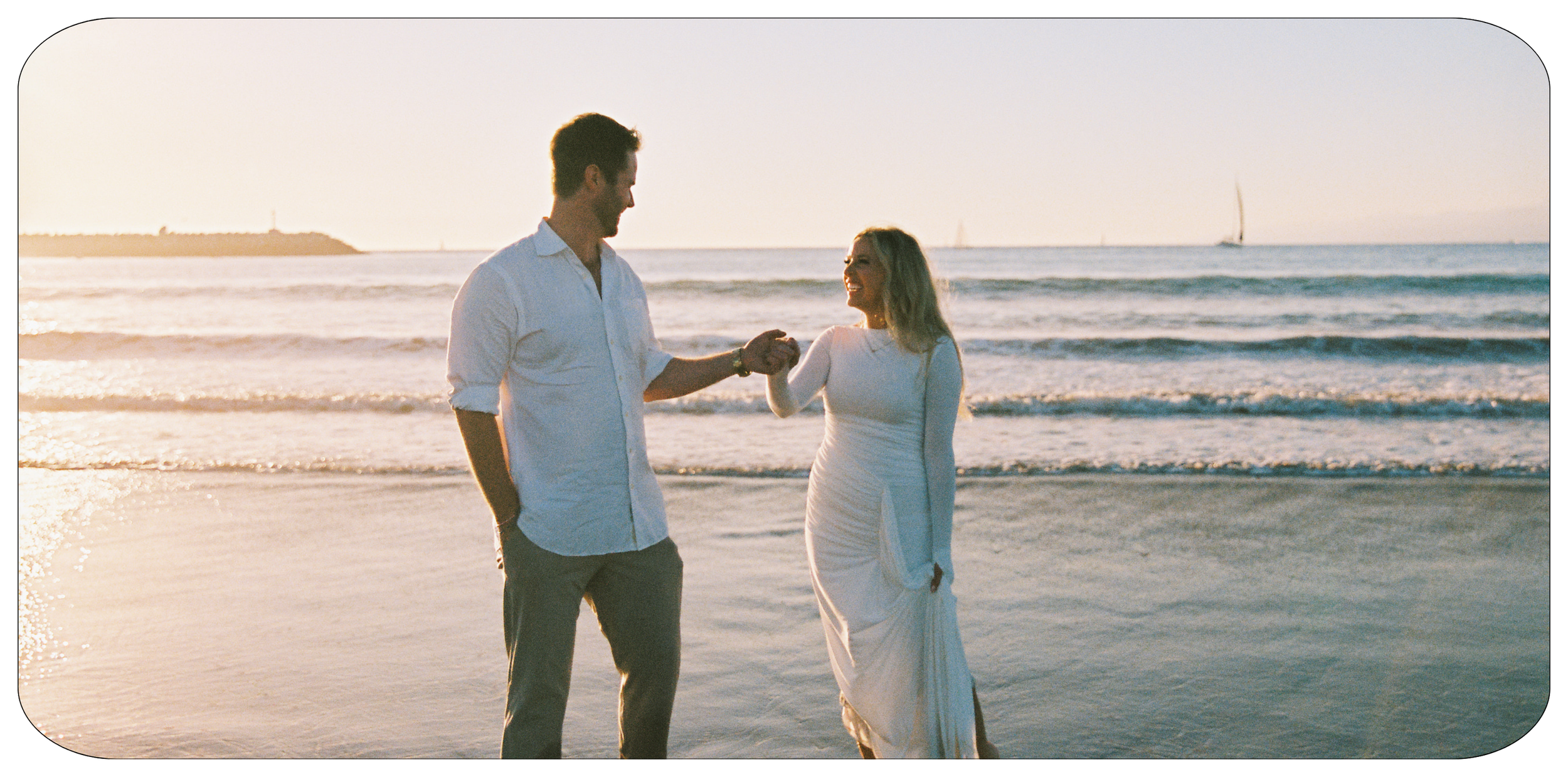 Couple walking along the shoreline during a golden hour beach engagement session in Marina Del Rey, CA.