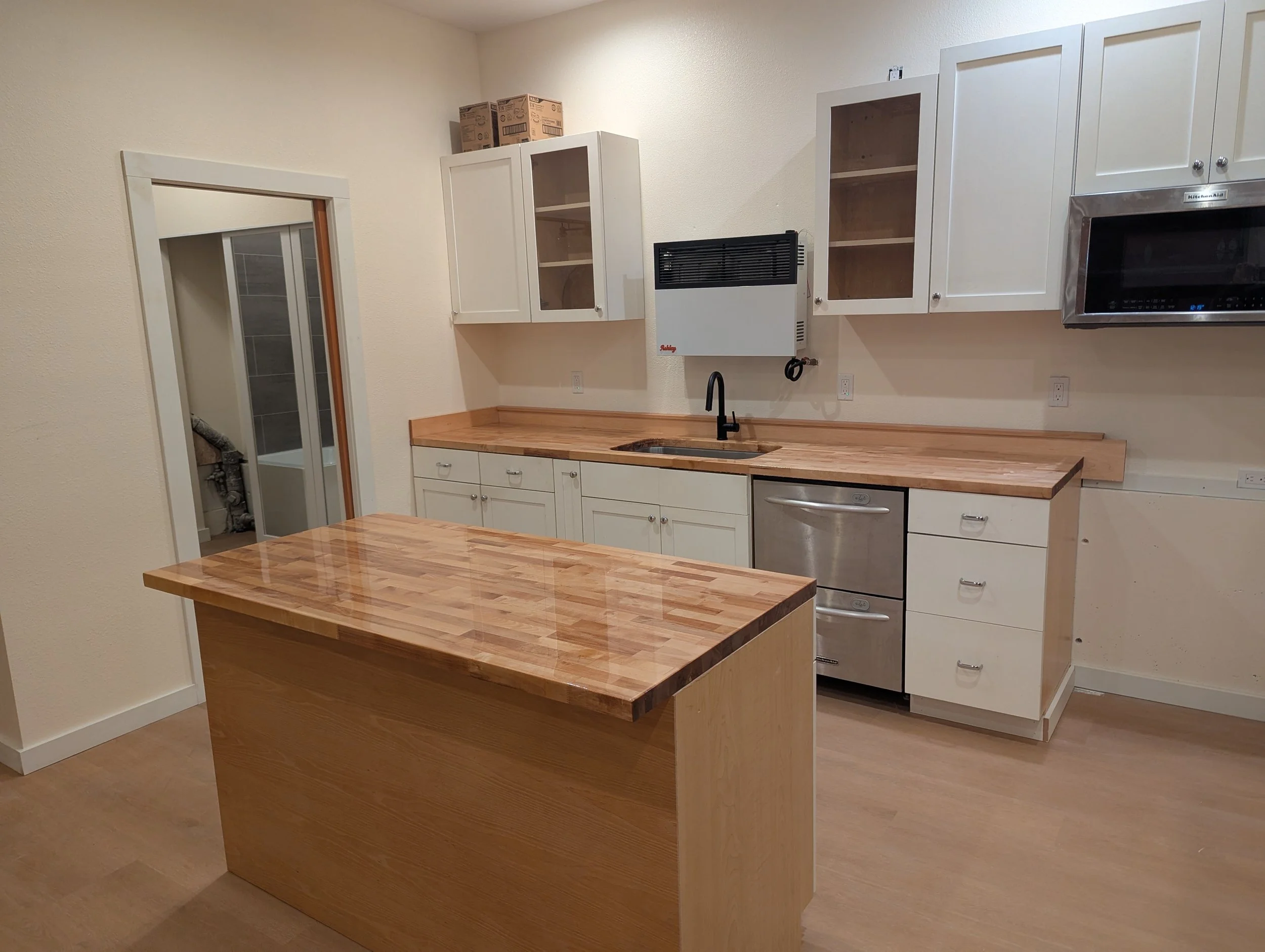 New bathroom, plumbing off the kitchen of this conversion ADU.