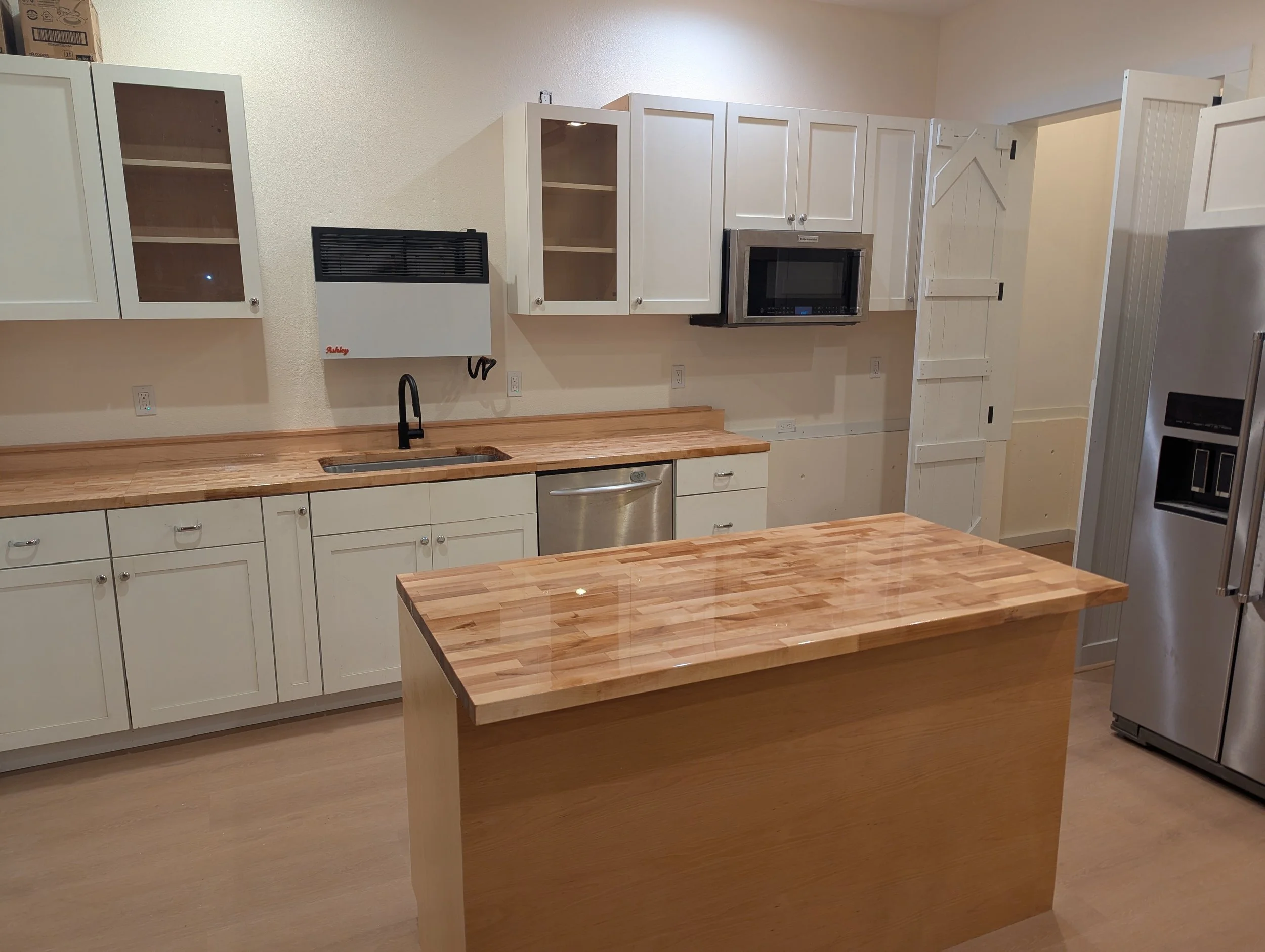 Custom countertops and island in the kitchen of an garage conversion to ADU.