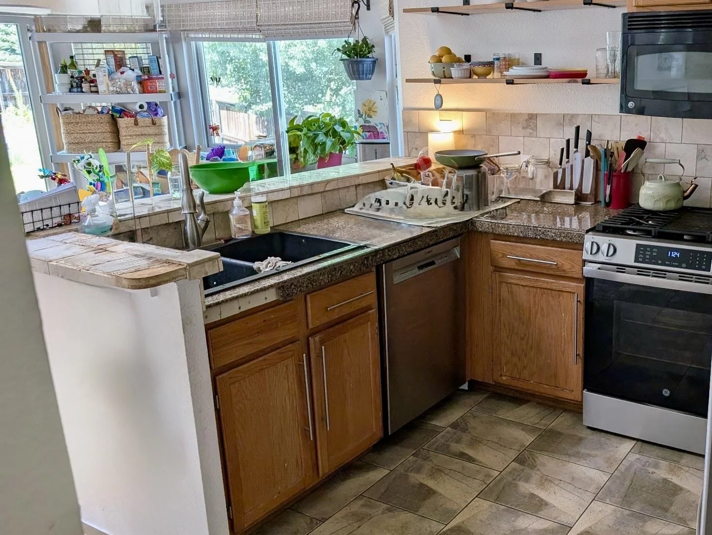 Before Highlands Ranch kitchen remodel with wood cabinets, dark countertops, and corner sink