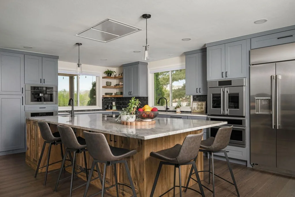 Custom kitchen remodel with gray cabinets, wood island, bar seating, and stainless appliances.