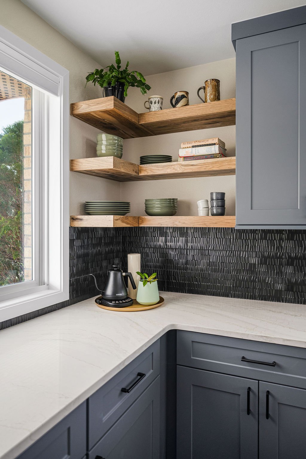 featuring gray cabinets, wood island, and quartz countertops