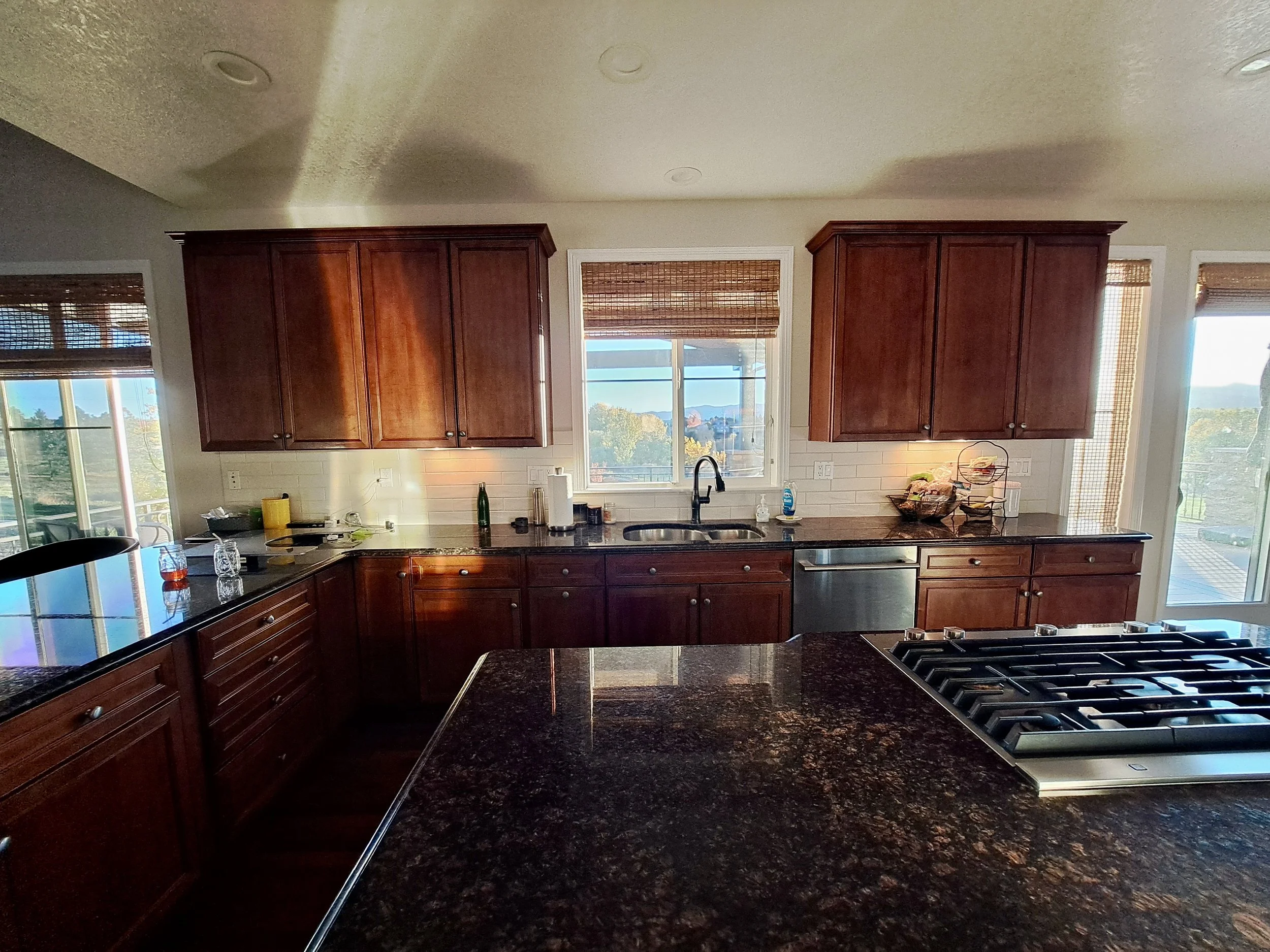 Kitchen before remodel in Highlands Ranch CO with cherry cabinets and dark countertops