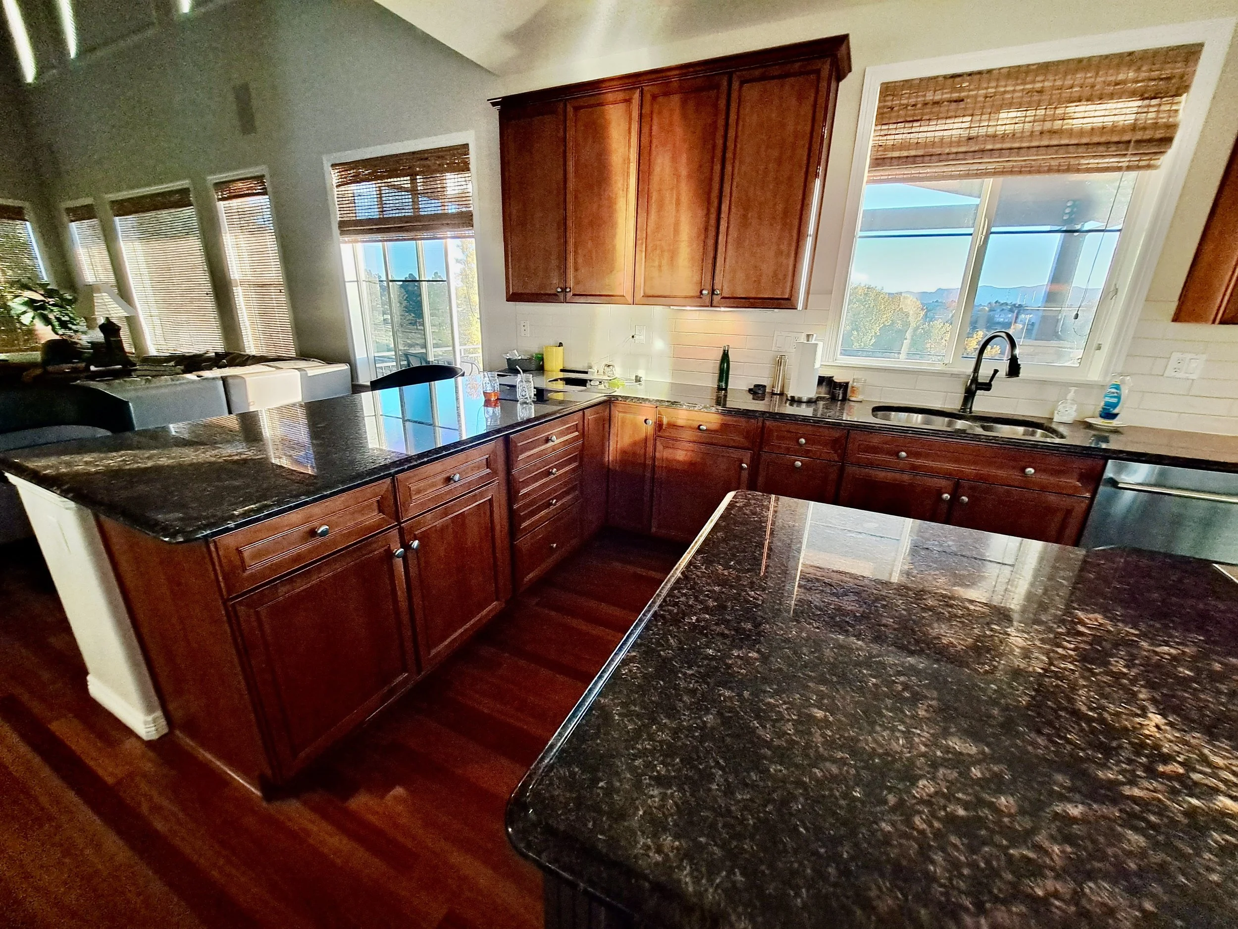 Cherry wood cabinetry and dark countertops before Highlands Ranch kitchen remodel
