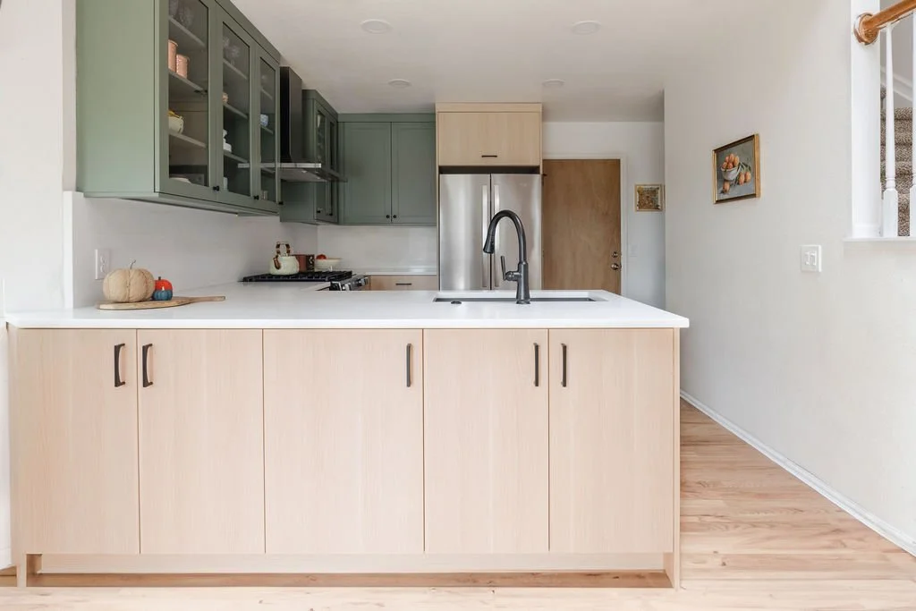 Two-tone Highlands Ranch kitchen remodel with green and natural wood cabinets and peninsula
