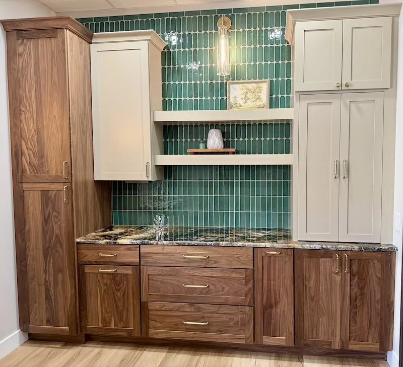 Custom Woodland cabinetry paired with rich natural wood grain, brass hardware, and a striking green tile backsplash for a warm modern statement.