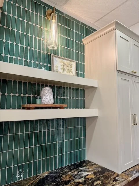 Designer tile backsplash paired with floating shelves and custom cabinetry creates a bold, modern focal point with elegant warmth.