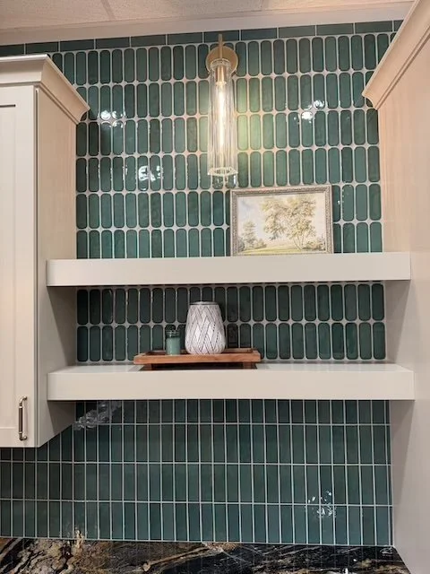 Statement backsplash with handcrafted texture, floating shelves, and premium cabinetry designed for both beauty and functionality.