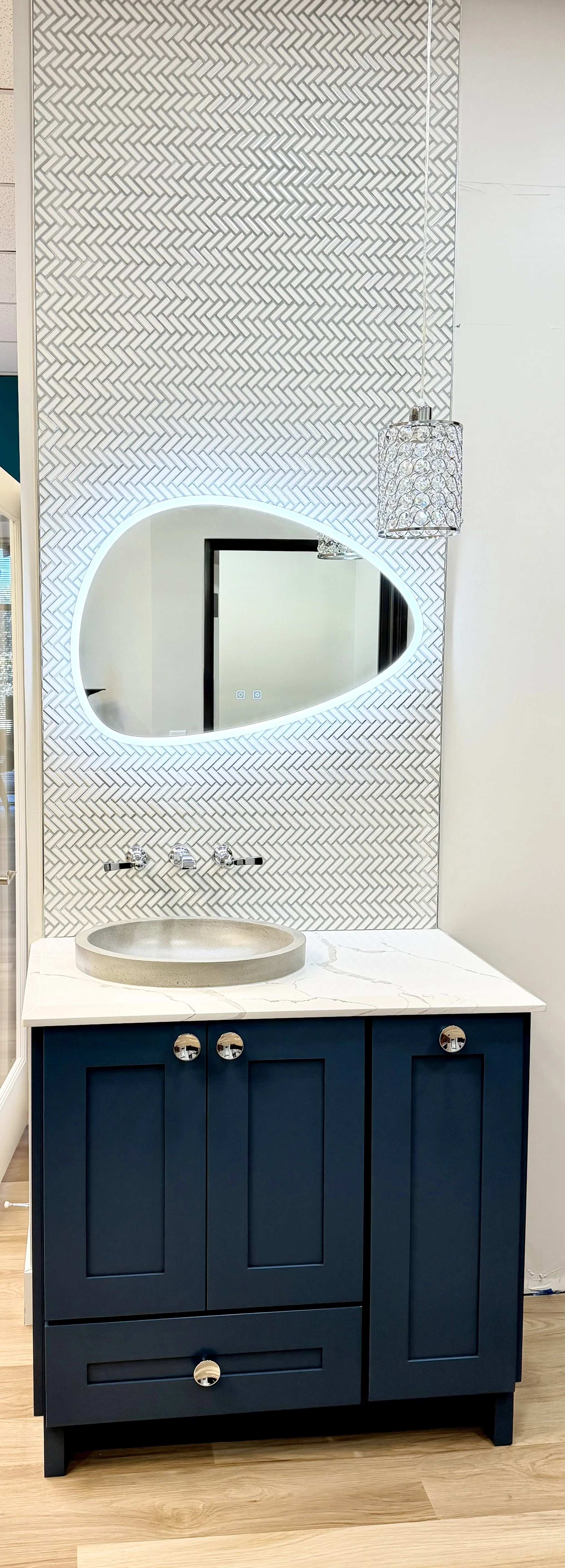 Contemporary bathroom remodel with custom vanity cabinetry, statement tilework, and modern lighting designed for a luxurious spa-inspired feel.