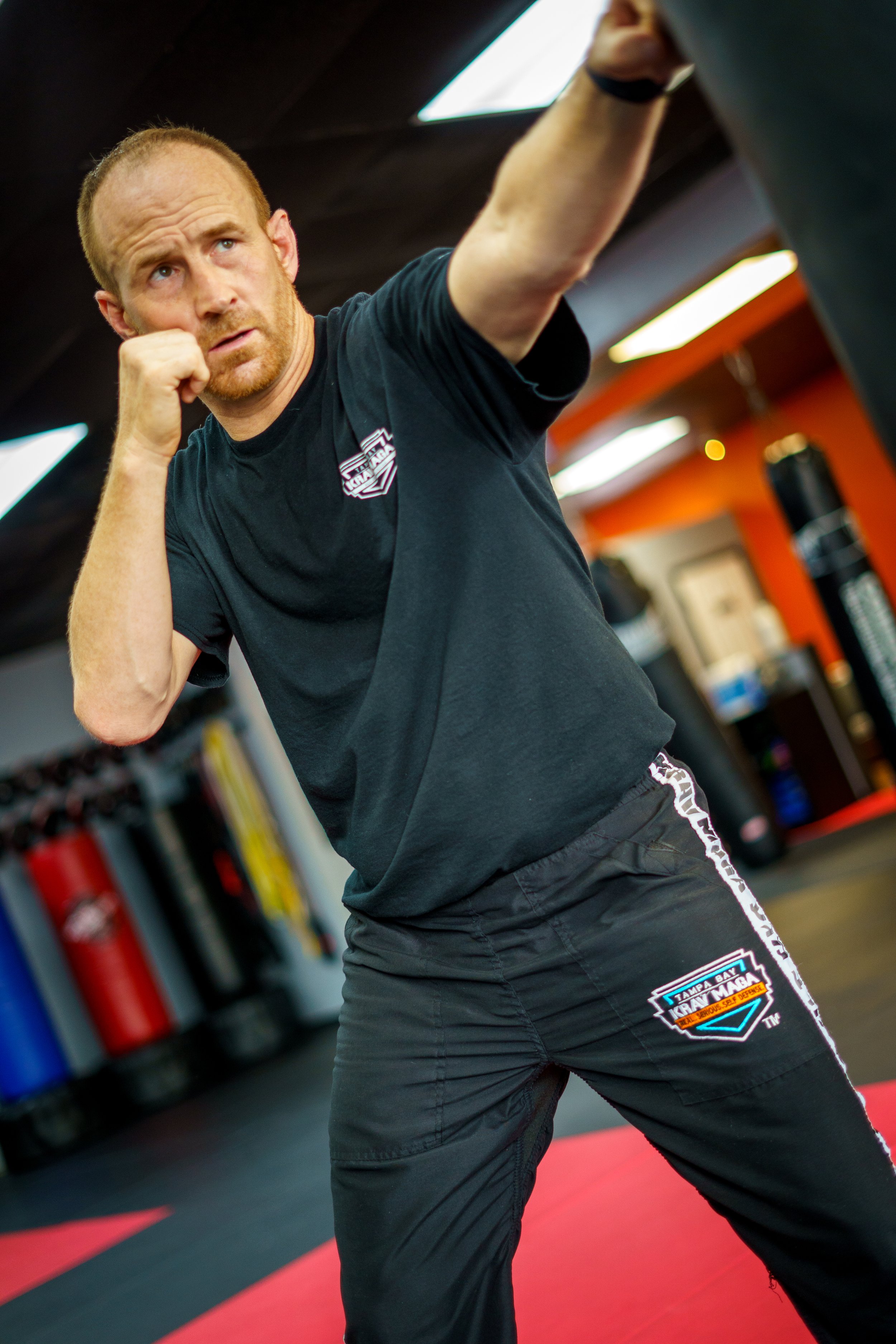 Action shot of a Tampa Bay Krav Maga instructor demonstrating a powerful punch during self-defense class in Clearwater, FL. Captures form, focus, and the precision of strike technique training.