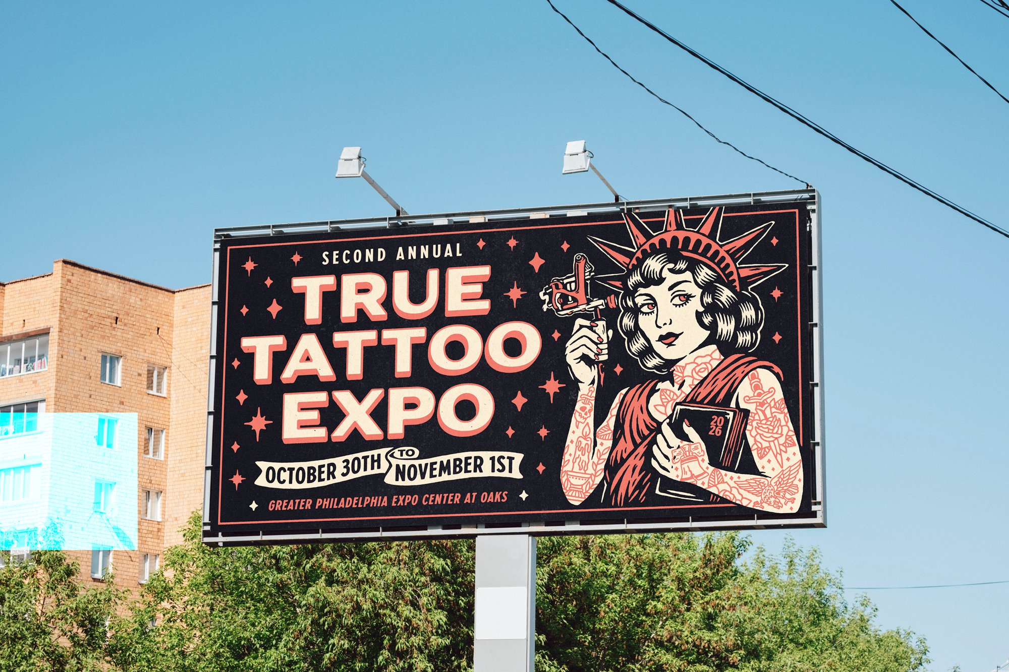 Billboard advertising the Second Annual True Tattoo Expo held from October 30th to November 1st at the Greater Philadelphia Expo Center at Oaks, featuring an illustration of a woman with tattoos holding a book and a spray gun, with a clear blue sky and buildings in the background.