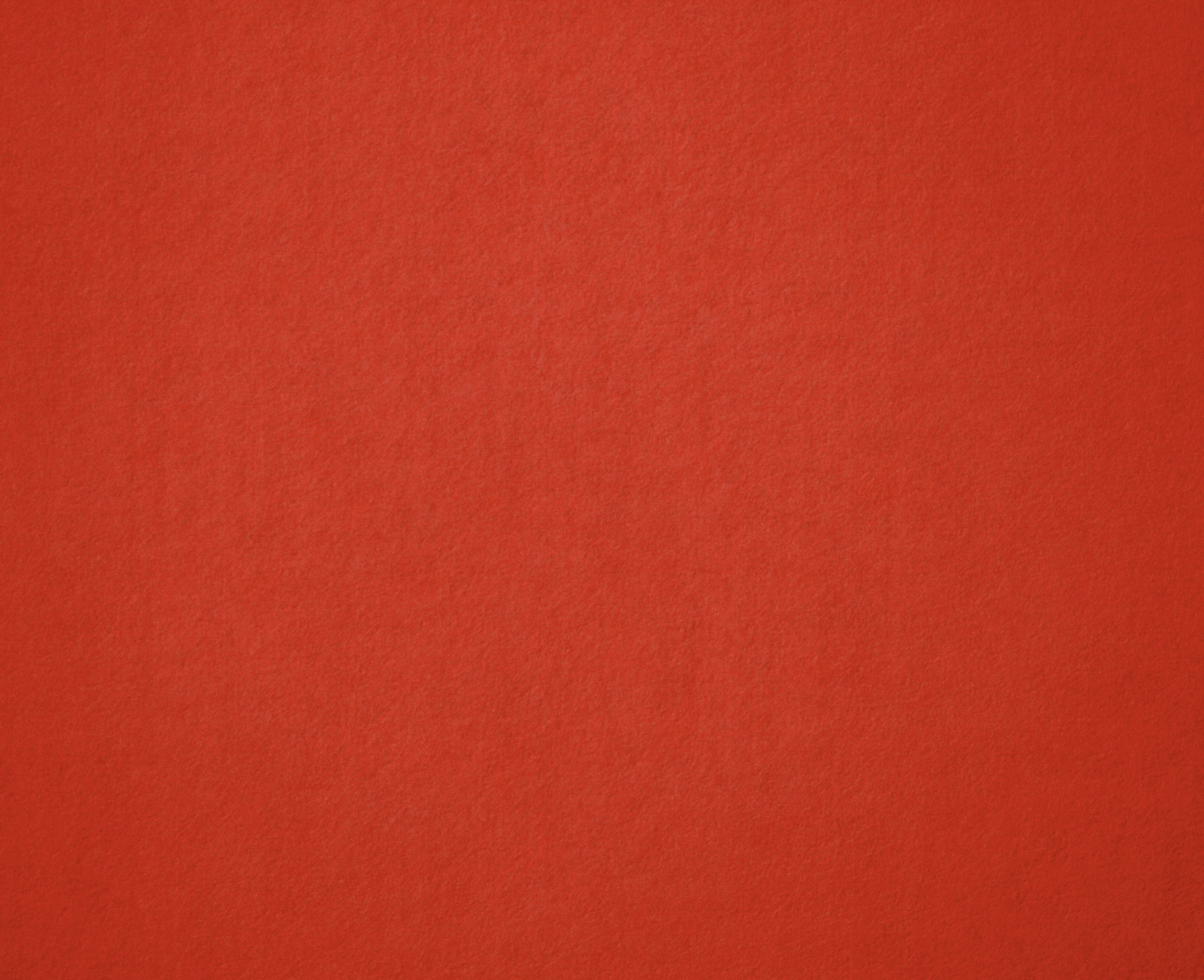 Close-up of a red textured fabric surface.