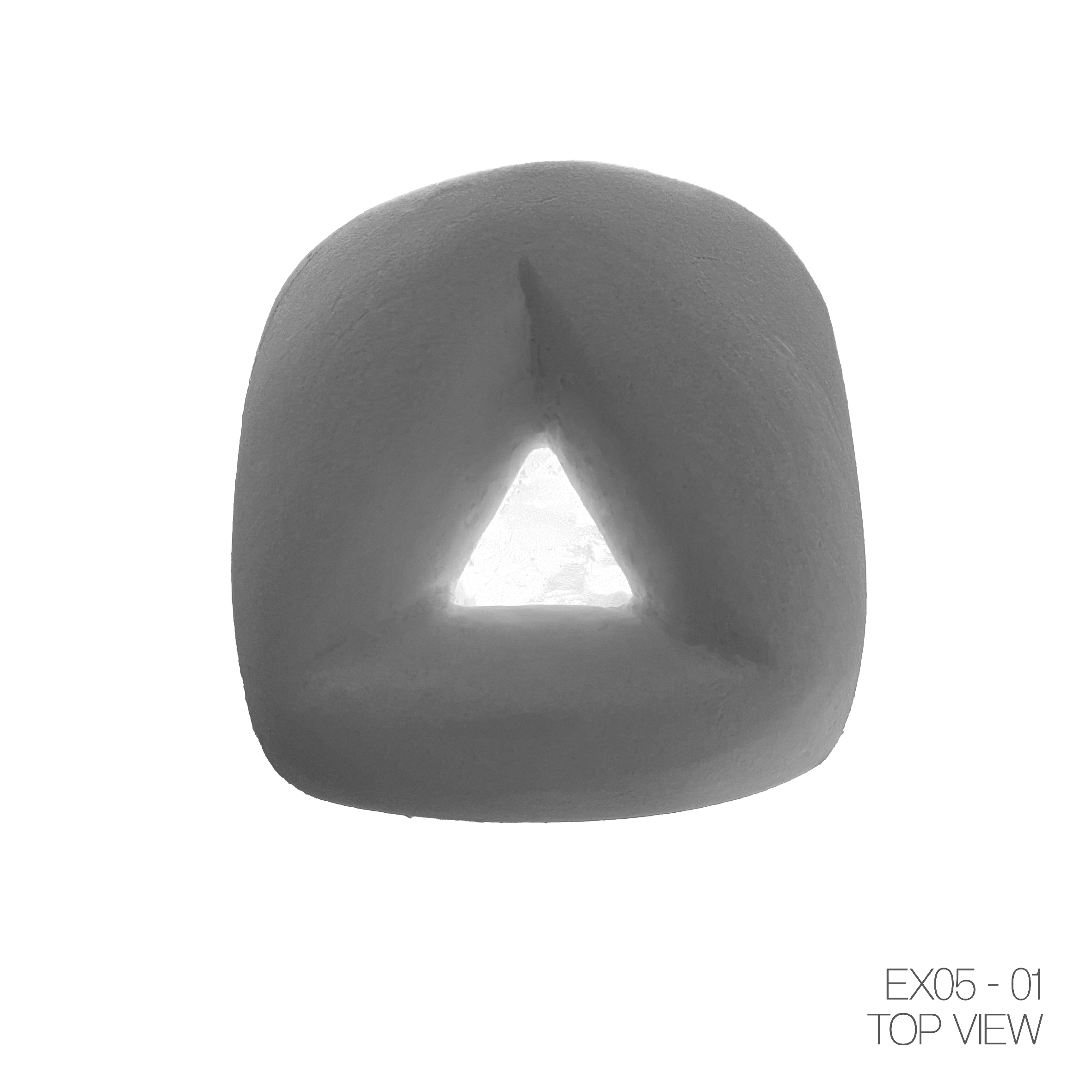 A close-up photograph of an object with a triangular opening at the top, viewed from above. The object appears to be made of a material with a slightly textured surface. There are some markings and notation in the bottom right corner indicating a top