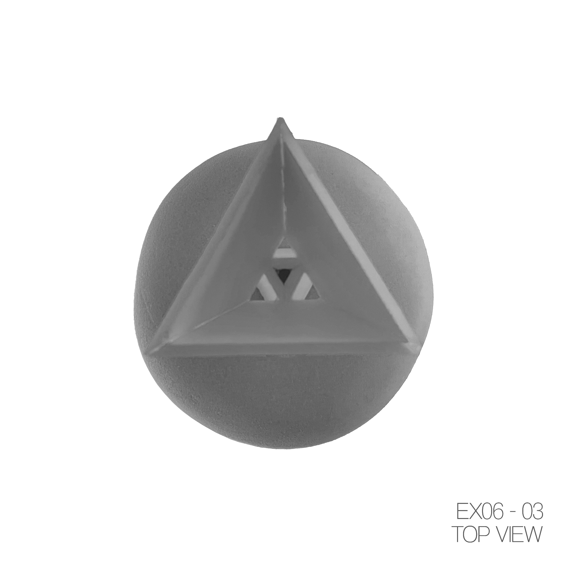 Top view of a spherical object with a triangular plastic structure on top, marked with the label 'EX06-03 TOP VIEW' in the bottom right corner.