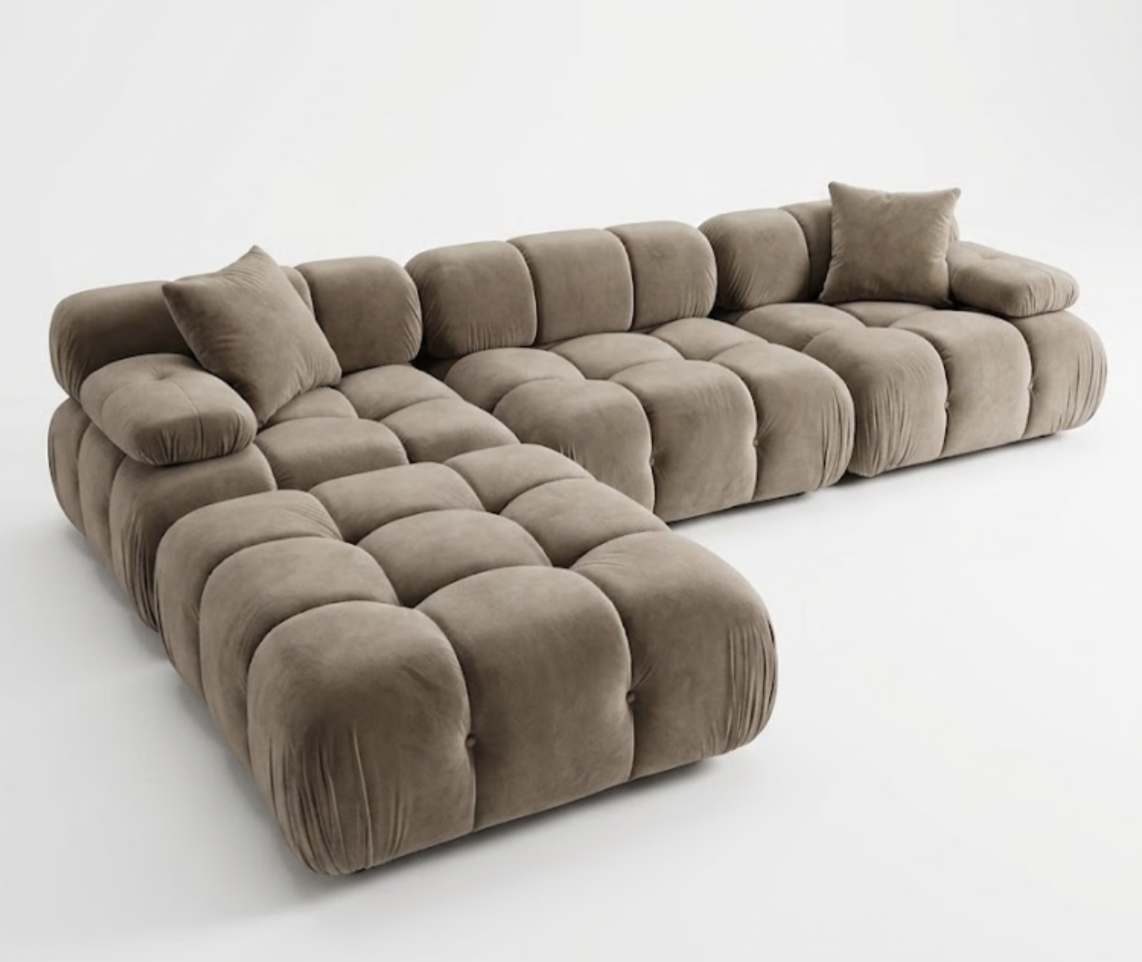 Large L-shaped brown tufted sectional sofa with matching pillows on a white background.