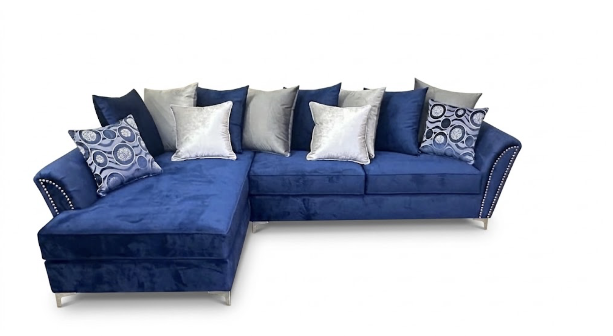 A blue sectional sofa with various patterned and solid-colored throw pillows against a plain white background.