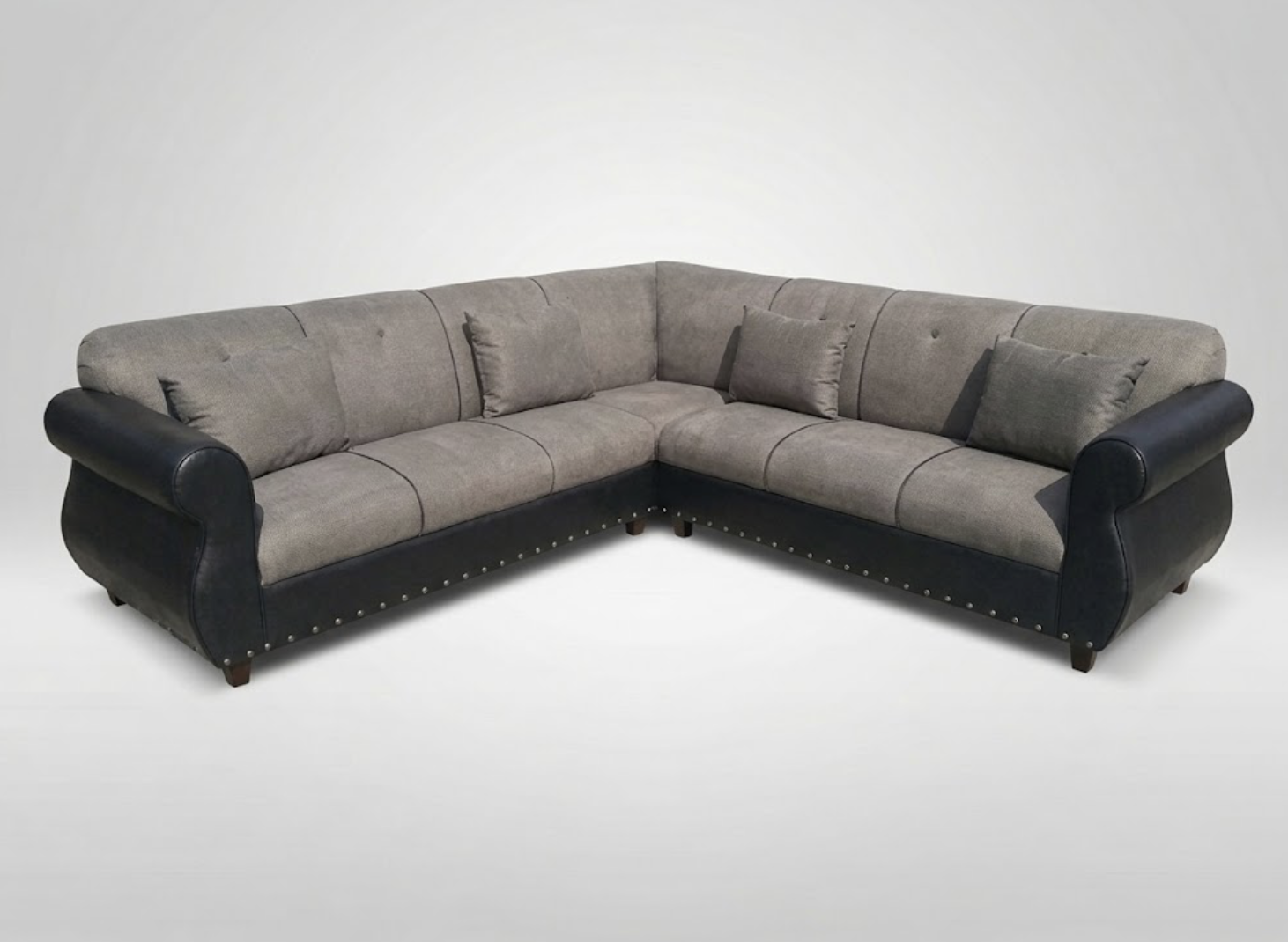 L-shaped sofa with gray fabric cushions and black leather armrests against a plain white background.