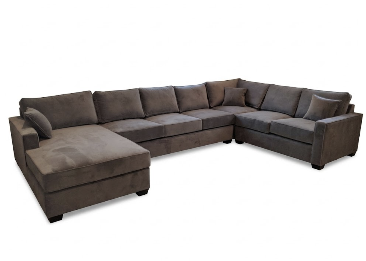 A large L-shaped gray sectional sofa with multiple cushions and pillows, set against a white background.