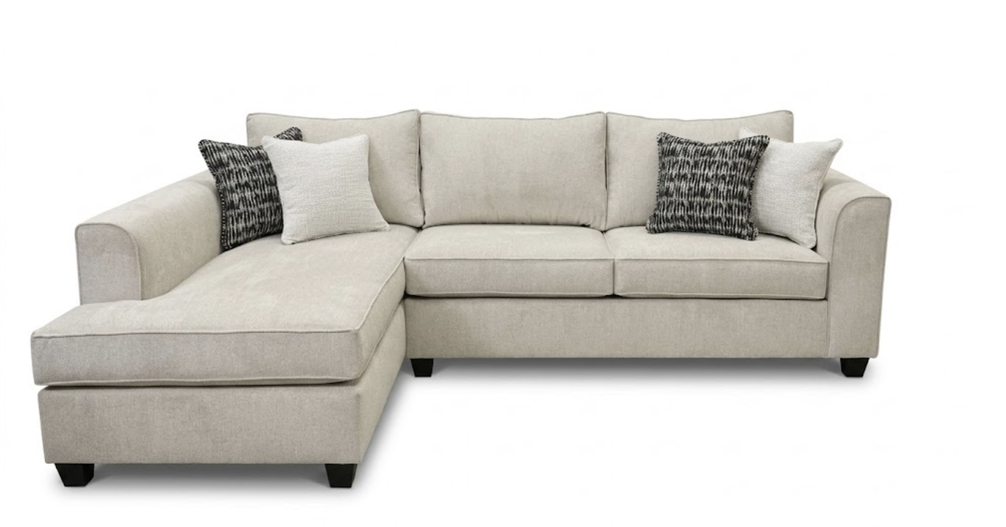 A beige sectional sofa with multiple decorative pillows, black legs, and a white background.