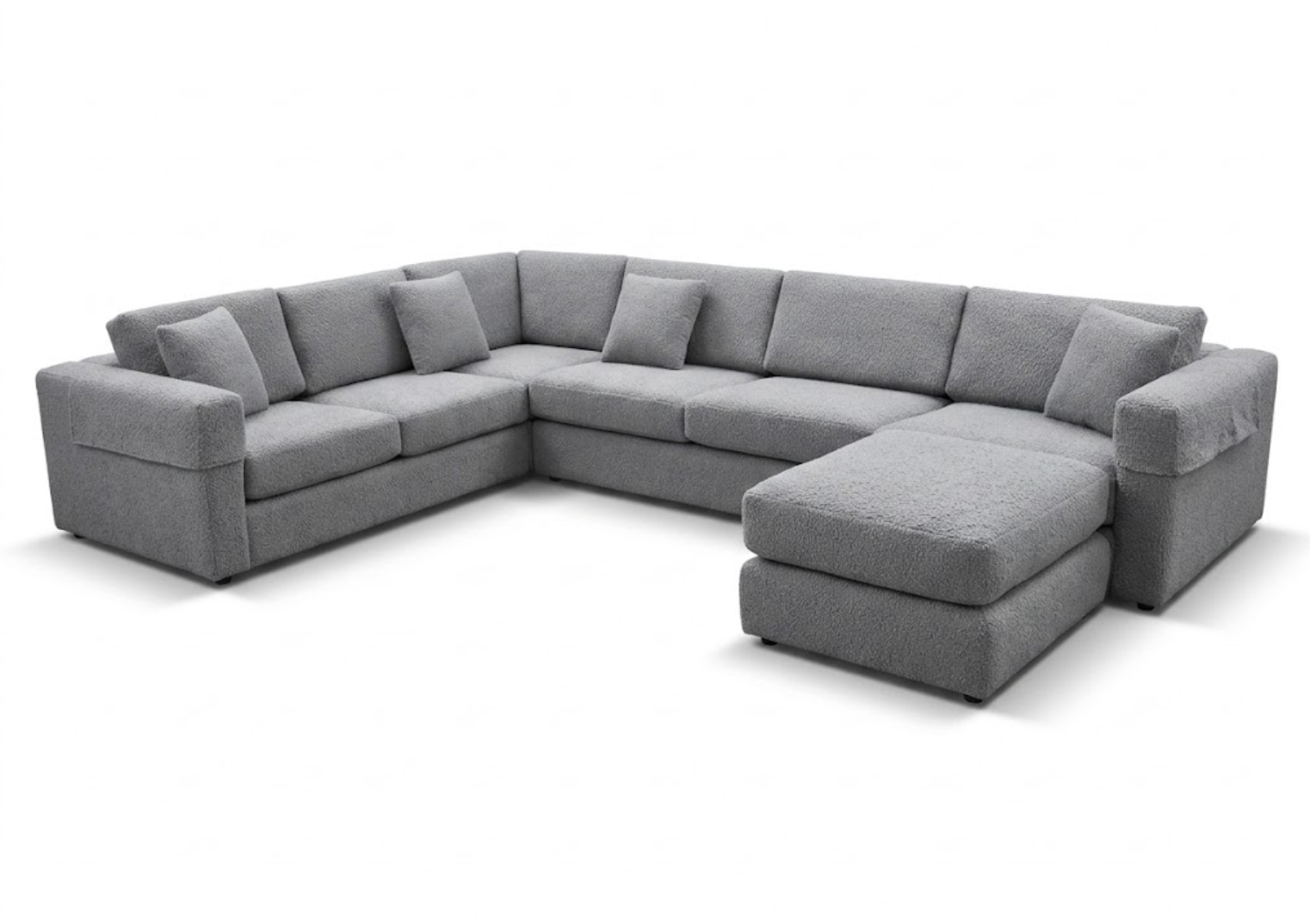 Gray sectional sofa with multiple cushions and an attached ottoman.