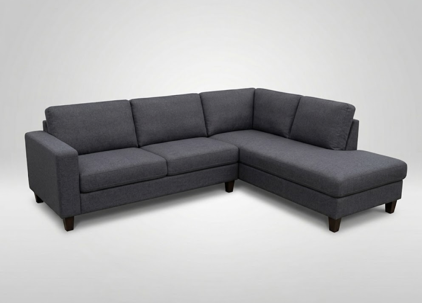 Dark gray sectional sofa with wooden legs against a plain white background.