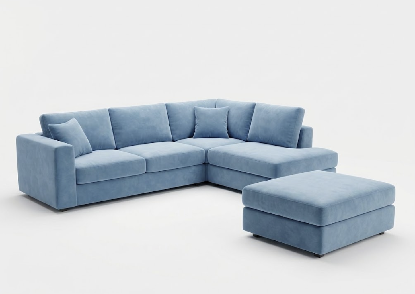 Light blue velvet sectional sofa with matching ottoman and throw pillows on a white background.