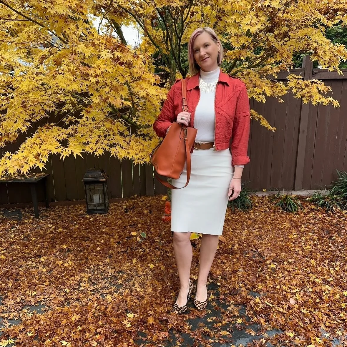 Too much cinnamon? Never.

When the temps drop, spice it up.
Our Stylist Pamela  goes all in on warm hues: a cinnamon bomber, cream mock neck, and cream leather skirt finished with animal print heels and a pumpkin hued bag. It&rsquo;s the sartorial e
