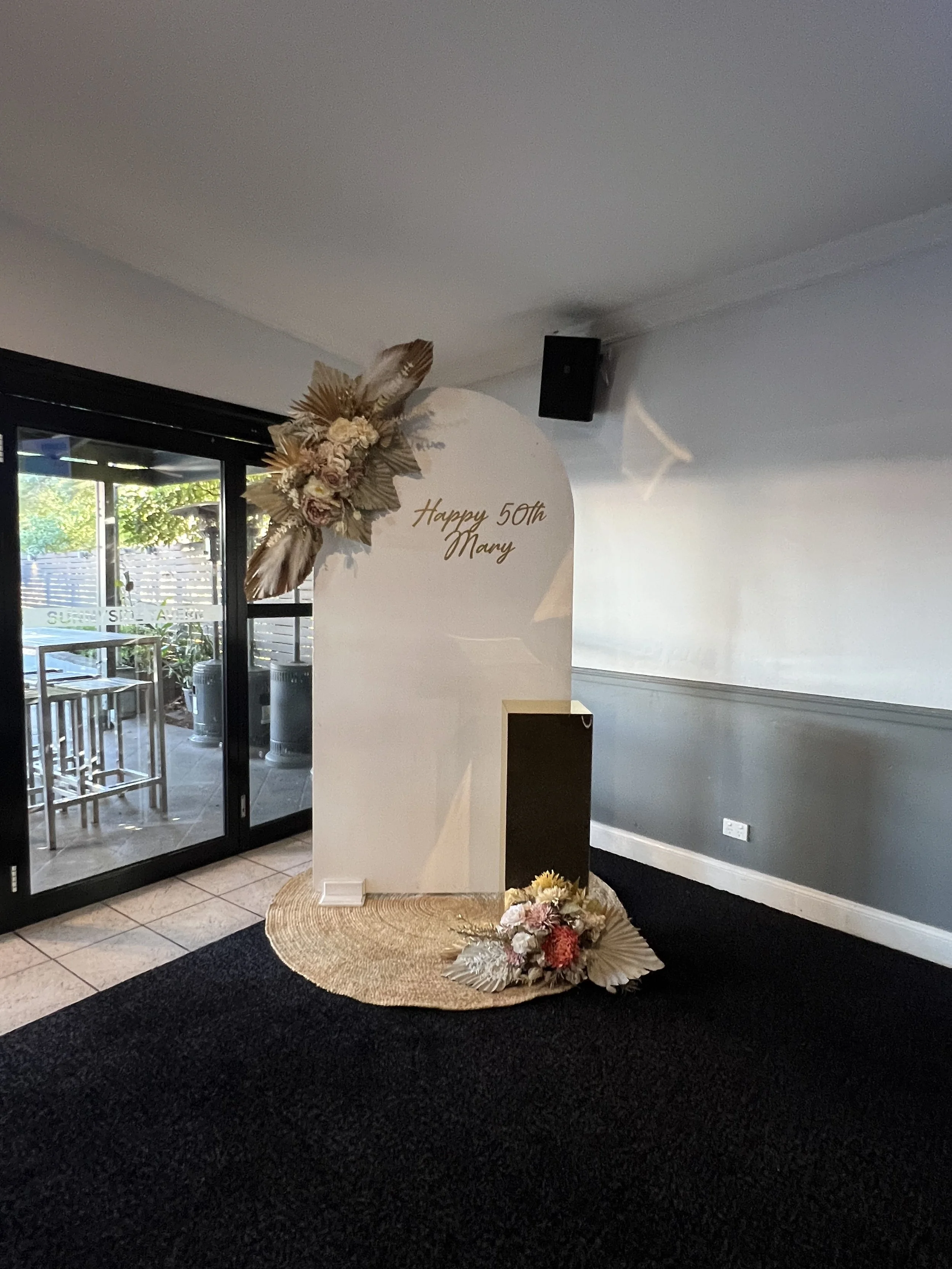 large white arch, juste rug, custom florals, gold mirror plinth, custom vinyl .jpg