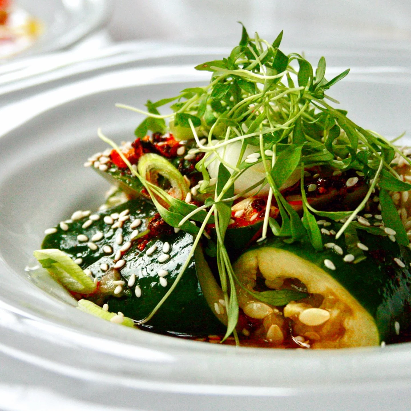Fresh, crisp cucumbers tossed in sesame soy dressing, topped with crunchy chili oil, scallion, and sesame seeds&mdash;refreshing with just the right kick #oldvillageinnogunquit