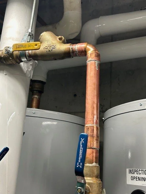 A licensed plumber repairing a leaking copper pipe with professional tools. Reliable plumbing services that prevent costly water damage and keep your home running smoothly