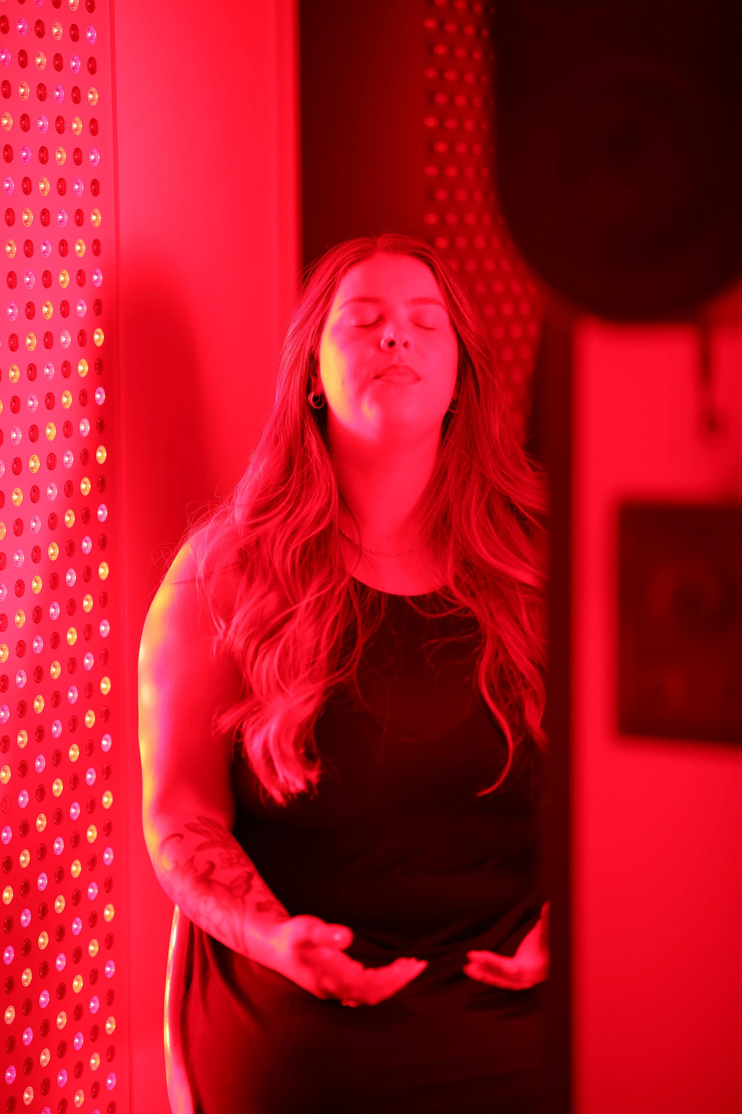 Ventura Red-light Lounge device glowing purple inside a red room.