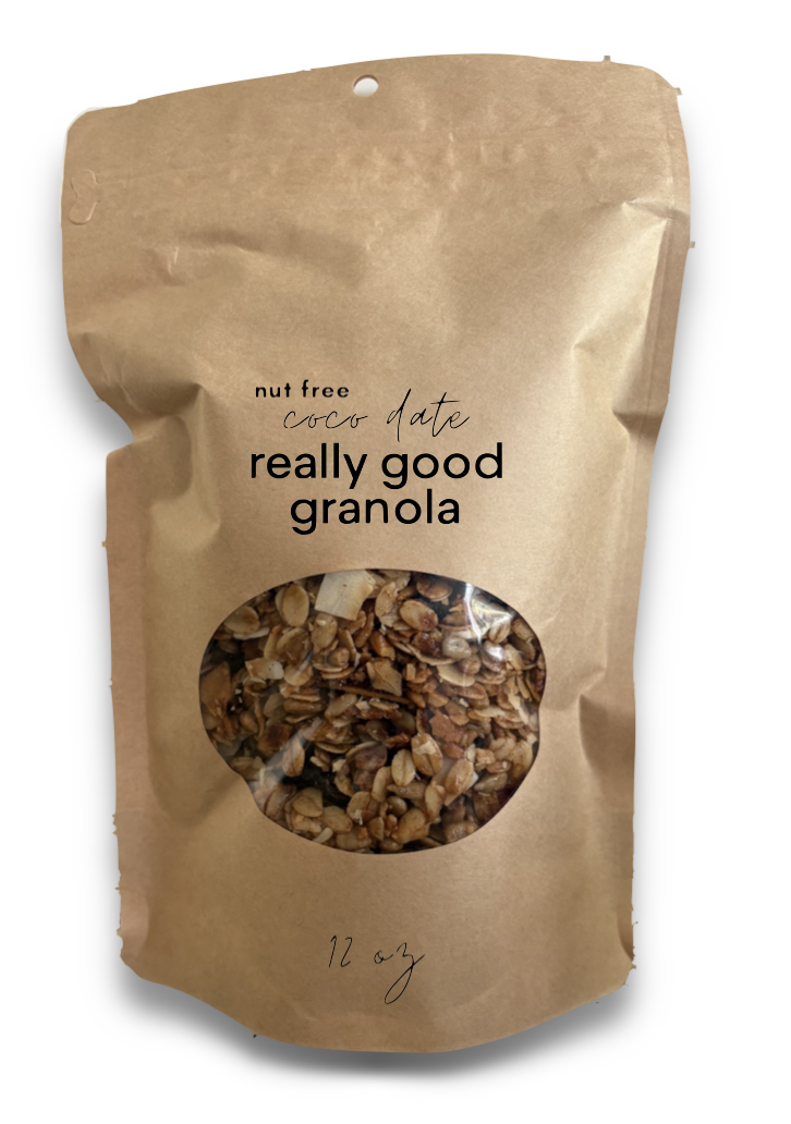 Brown paper bag of granola with a clear window showing chopped nuts and oats inside, labeled as 'really good granola', 'nut free', 'coco date', and '12 oz'.